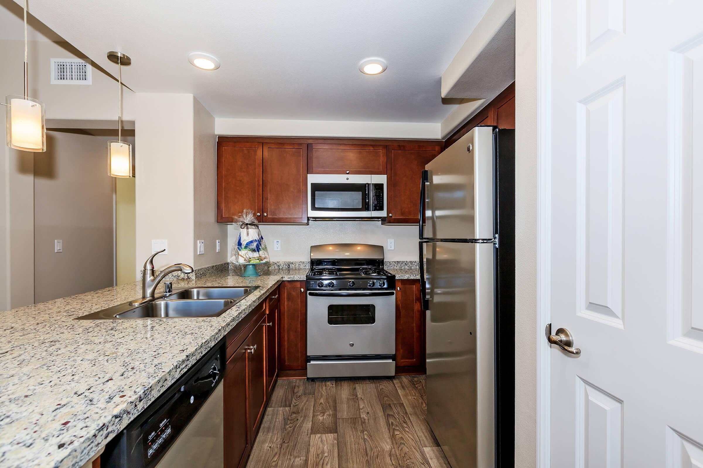 a kitchen with a stove sink and refrigerator