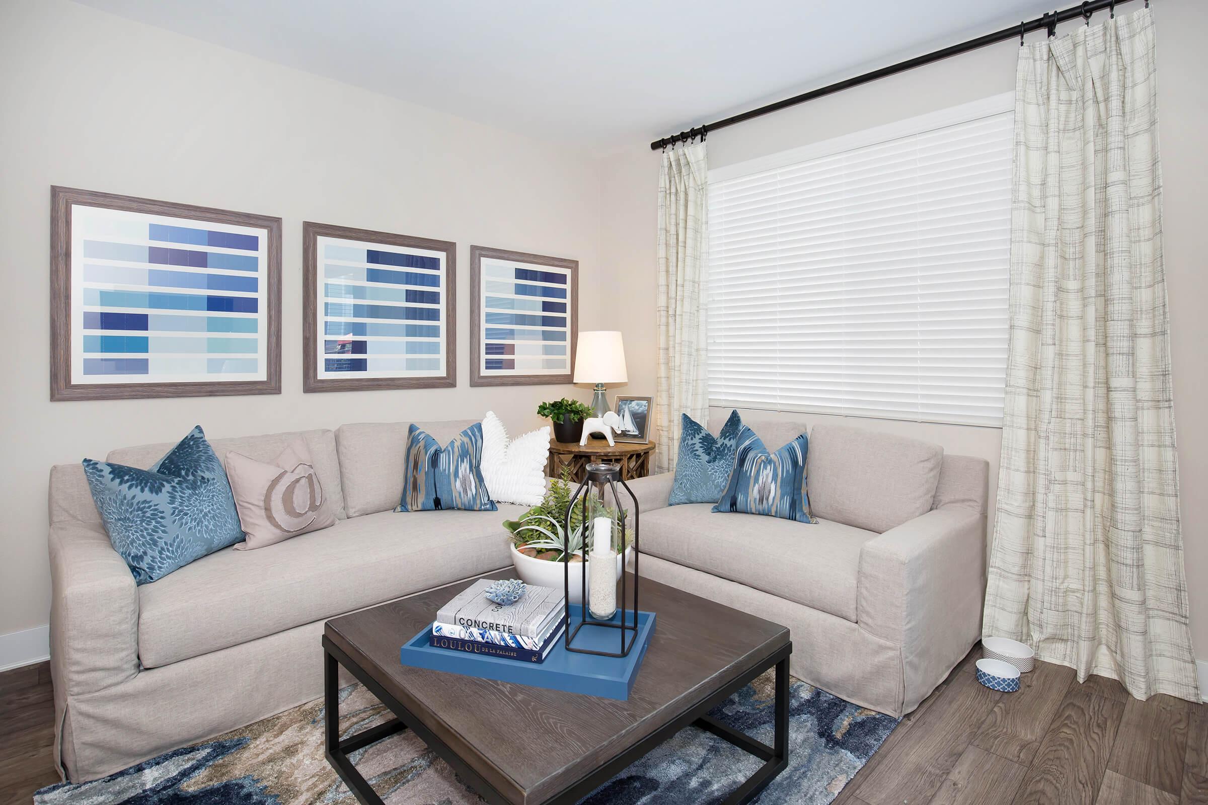 a living room filled with furniture and a large window