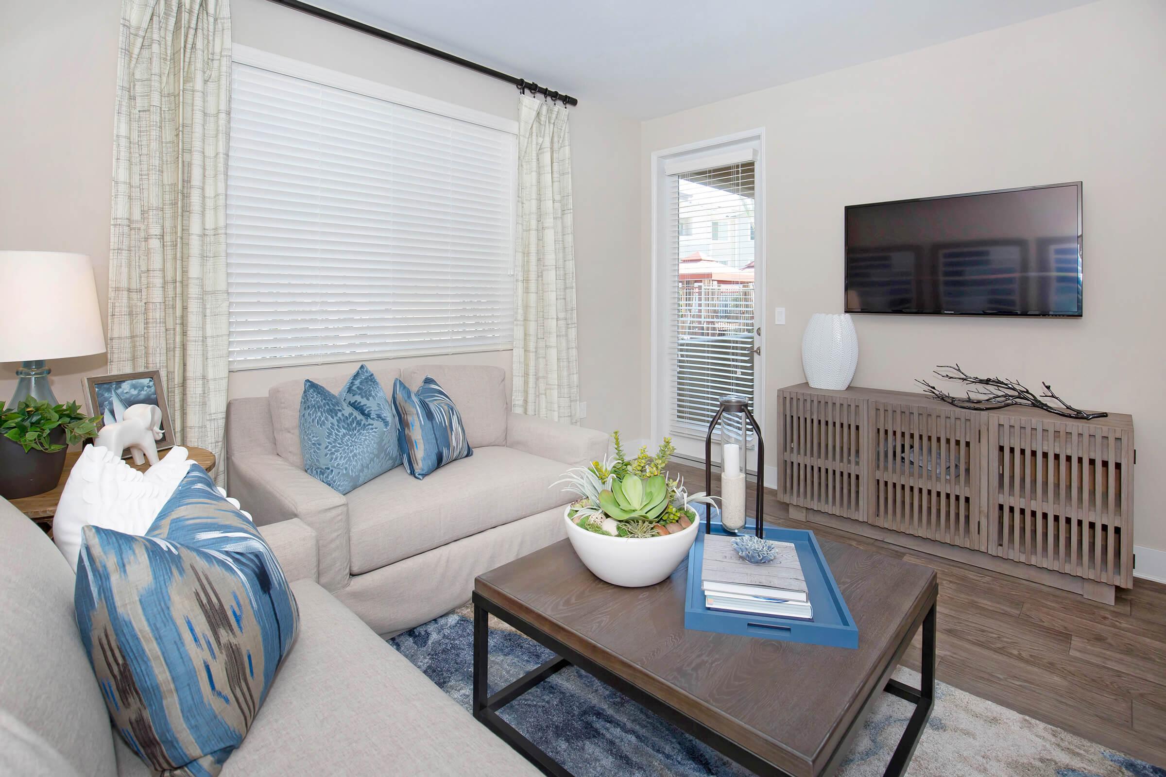 a living room filled with furniture and a window