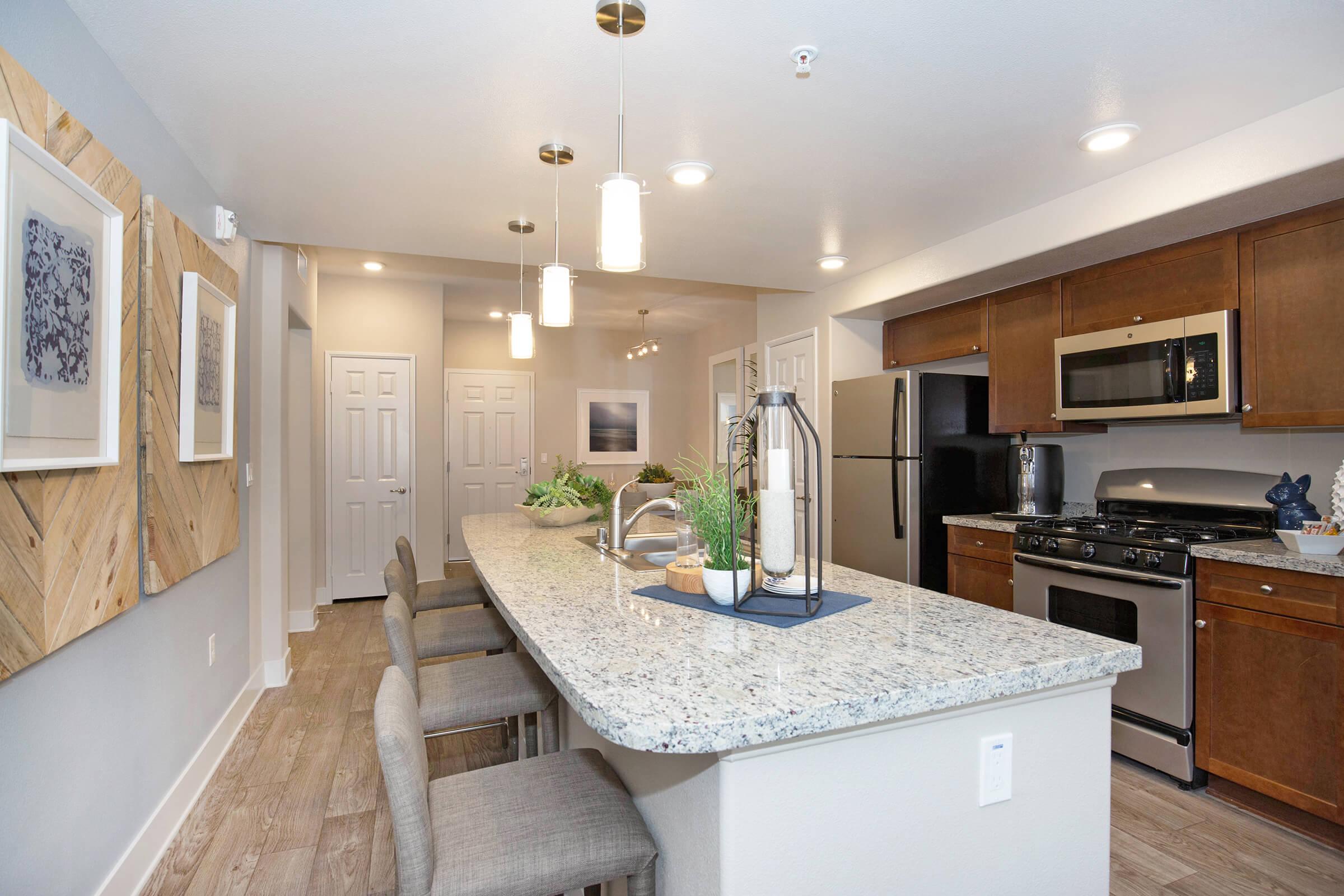 a modern kitchen with an island in the middle of a room