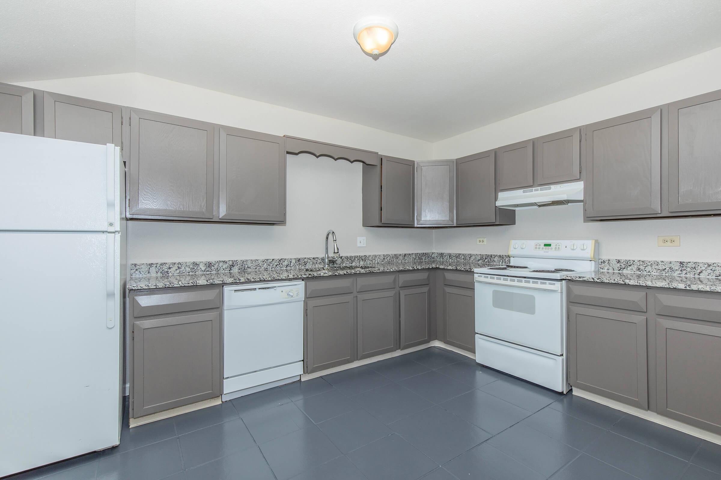 a kitchen with a stove and a refrigerator