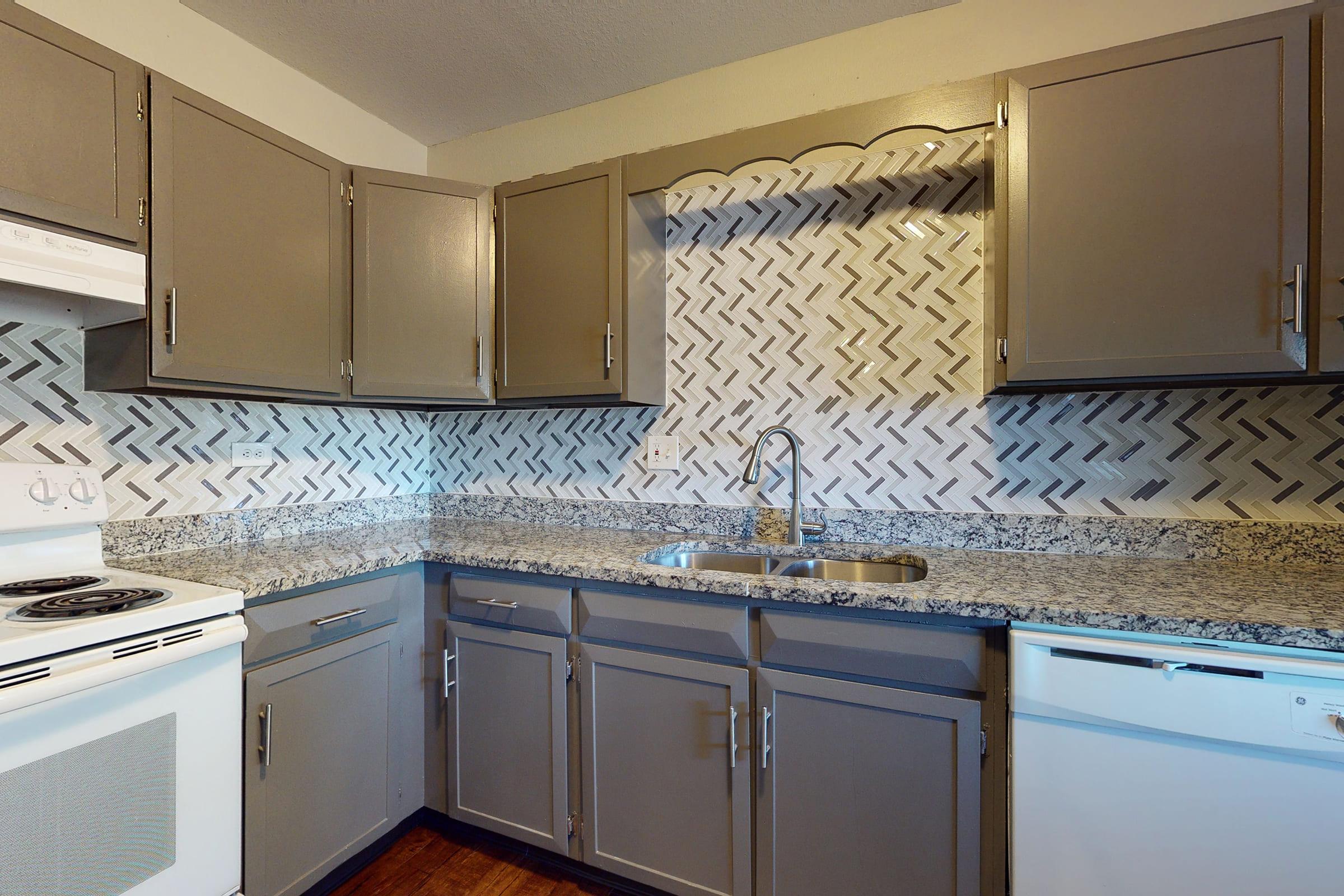 a kitchen with a stove a sink and a microwave oven above a refrigerator