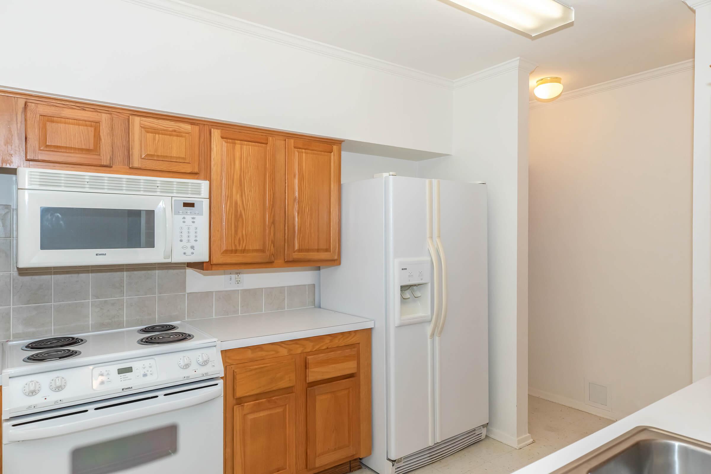 a kitchen with a stove a sink and a microwave