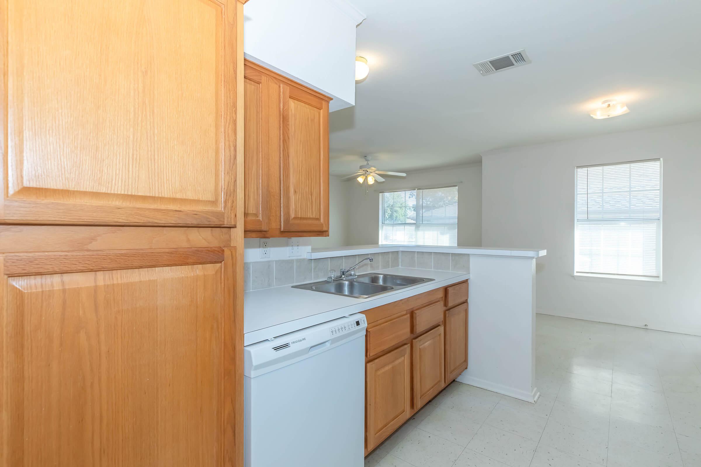 a kitchen with a sink and a refrigerator