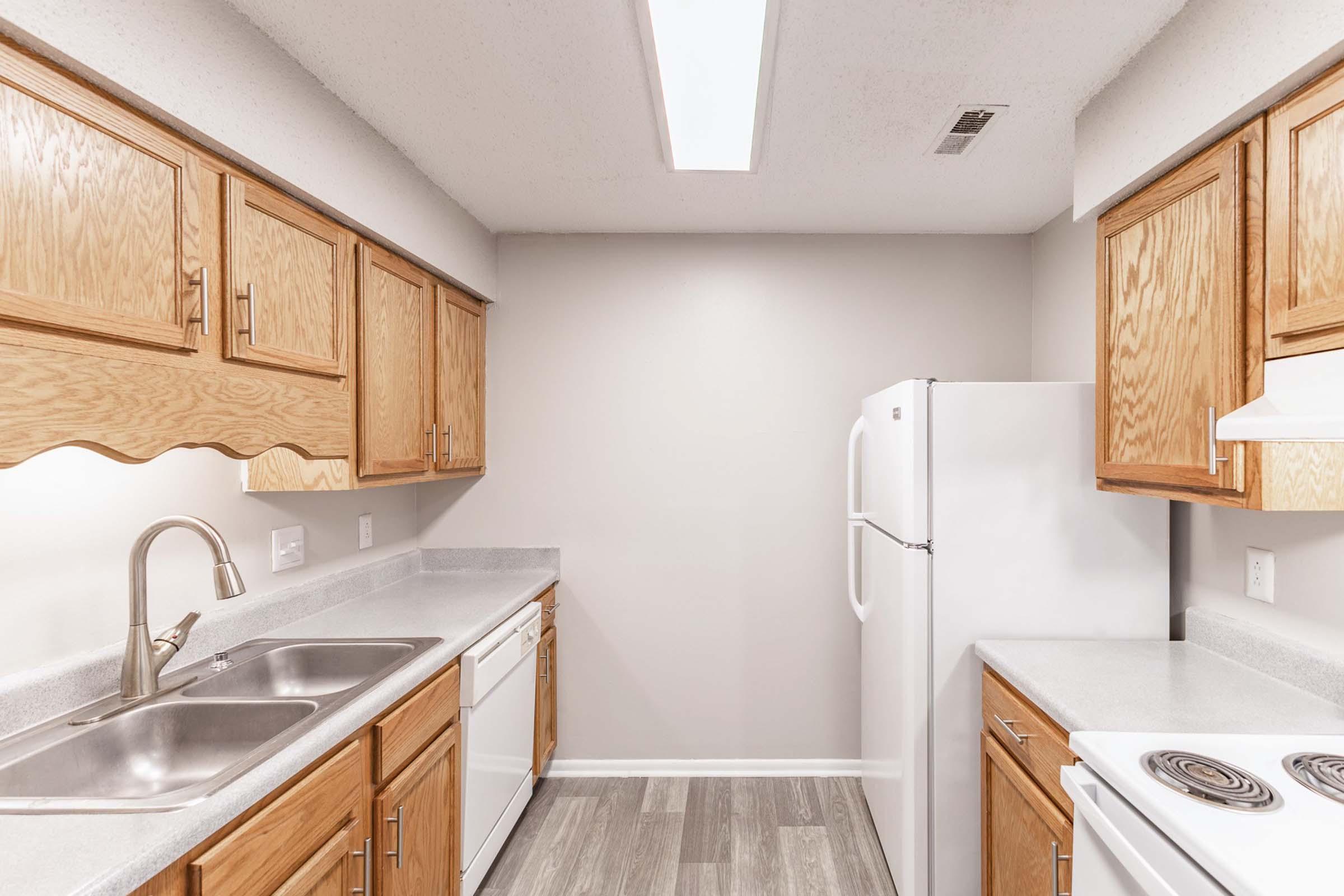 a kitchen with stainless steel appliances and wooden cabinets