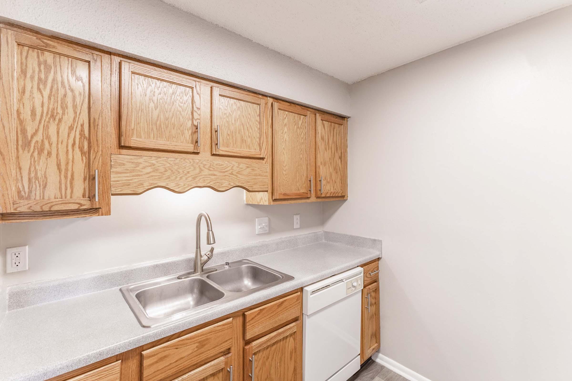 a kitchen with wooden cabinets and a sink