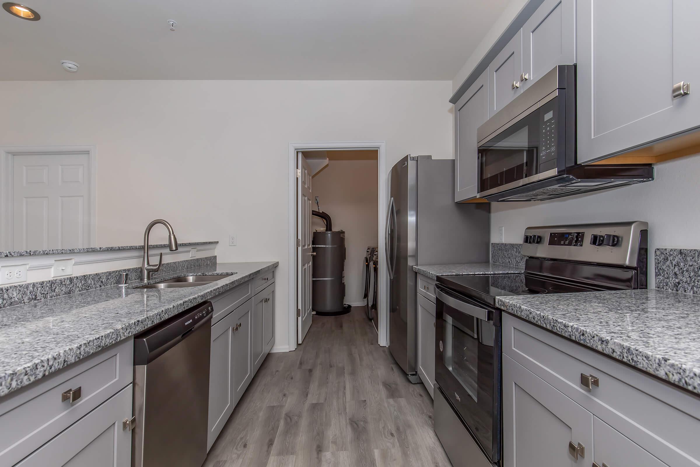 a kitchen with stainless steel appliances and wooden cabinets