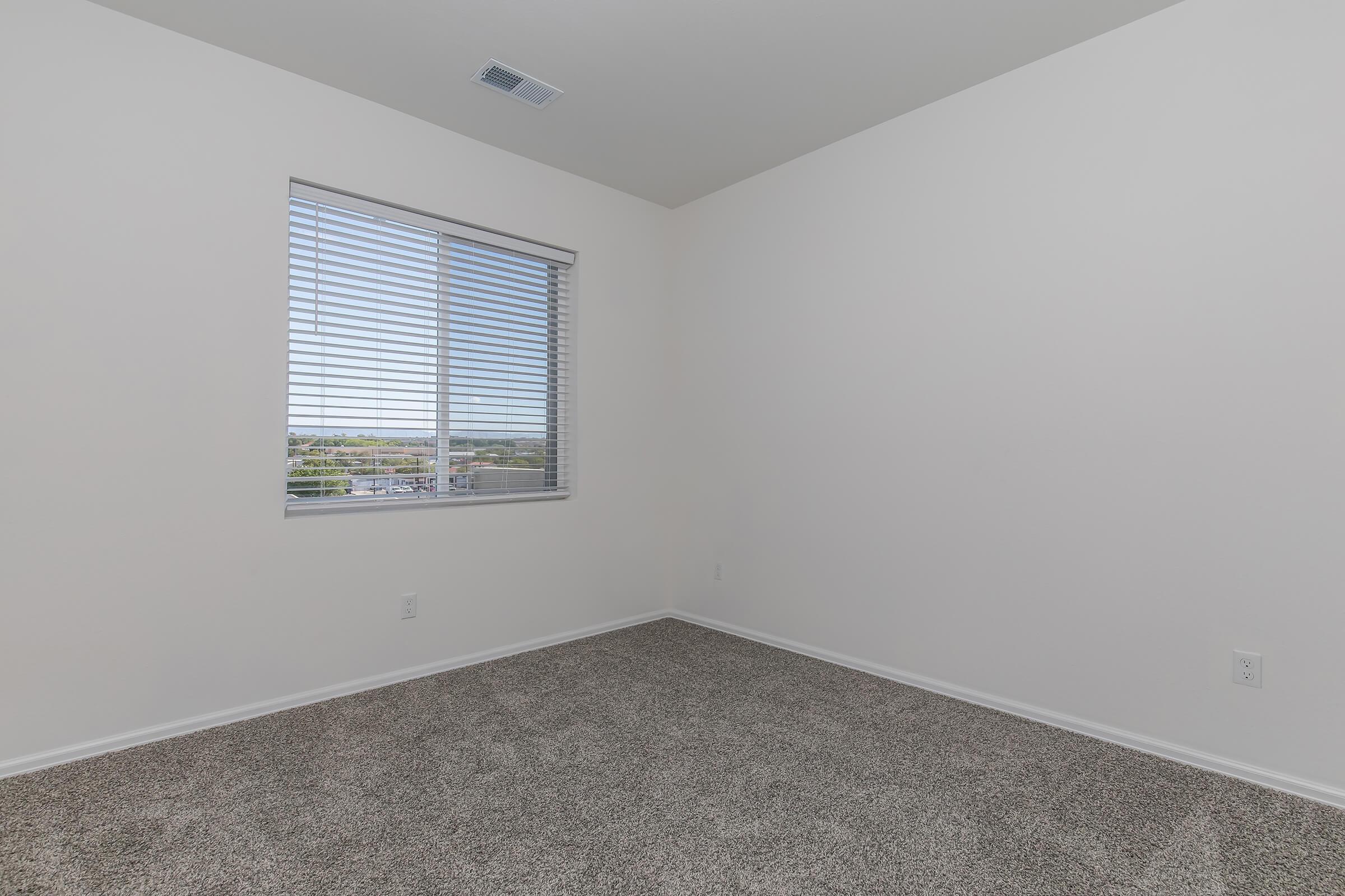 a bedroom with a large window