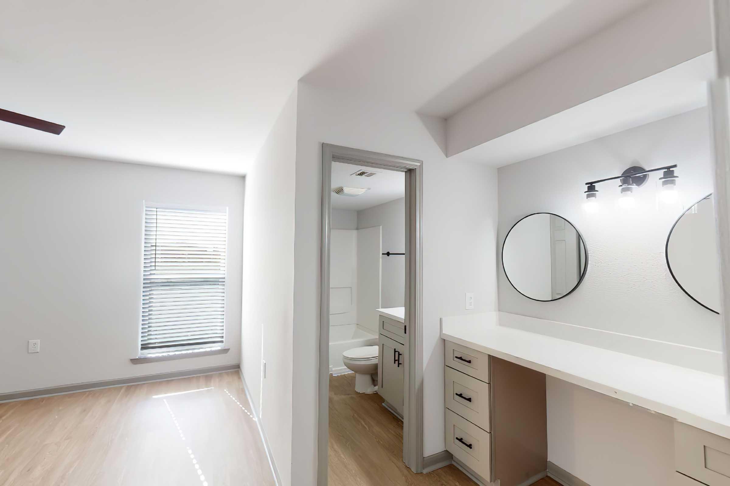 a kitchen with a sink and a mirror