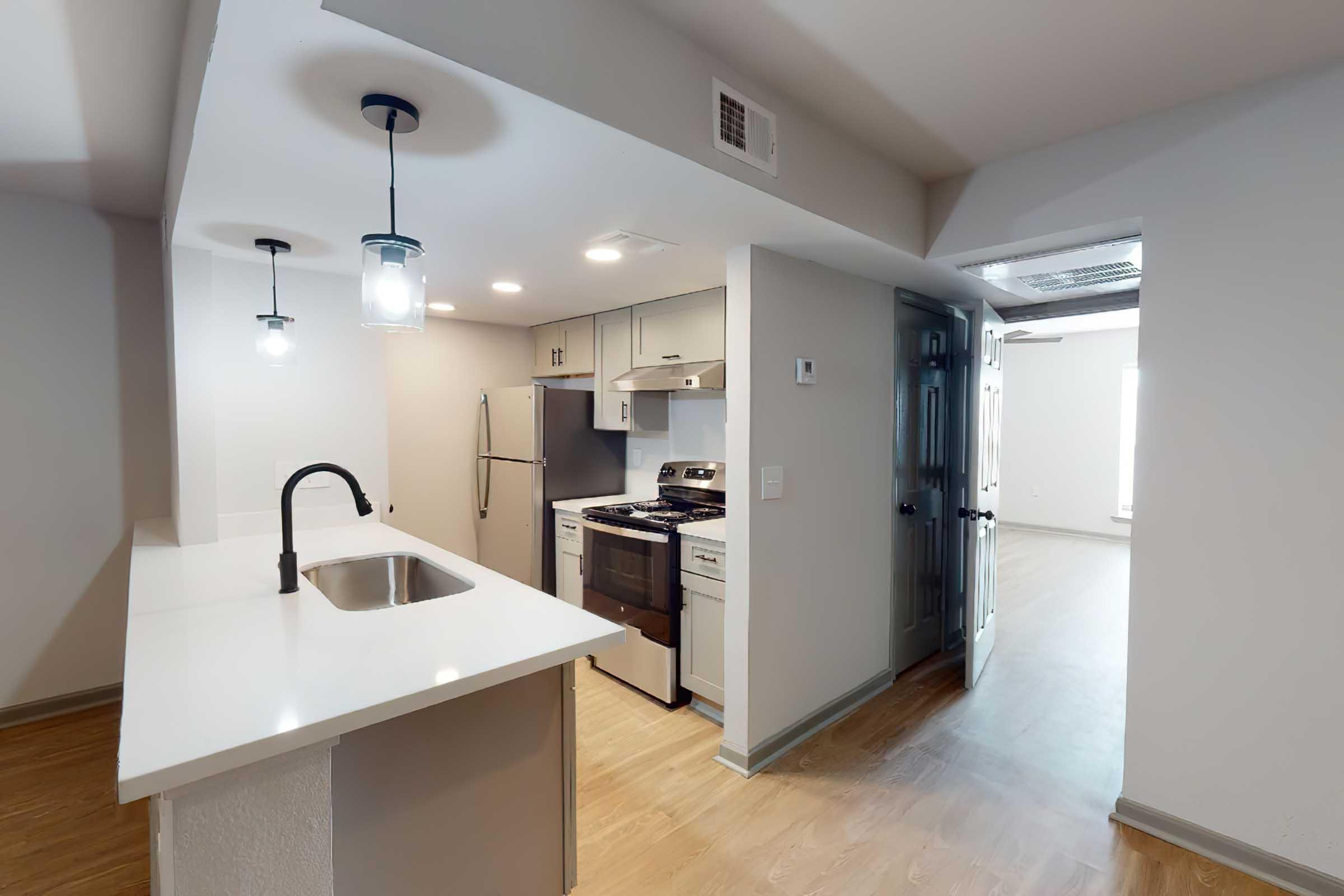 a kitchen with a sink and a mirror