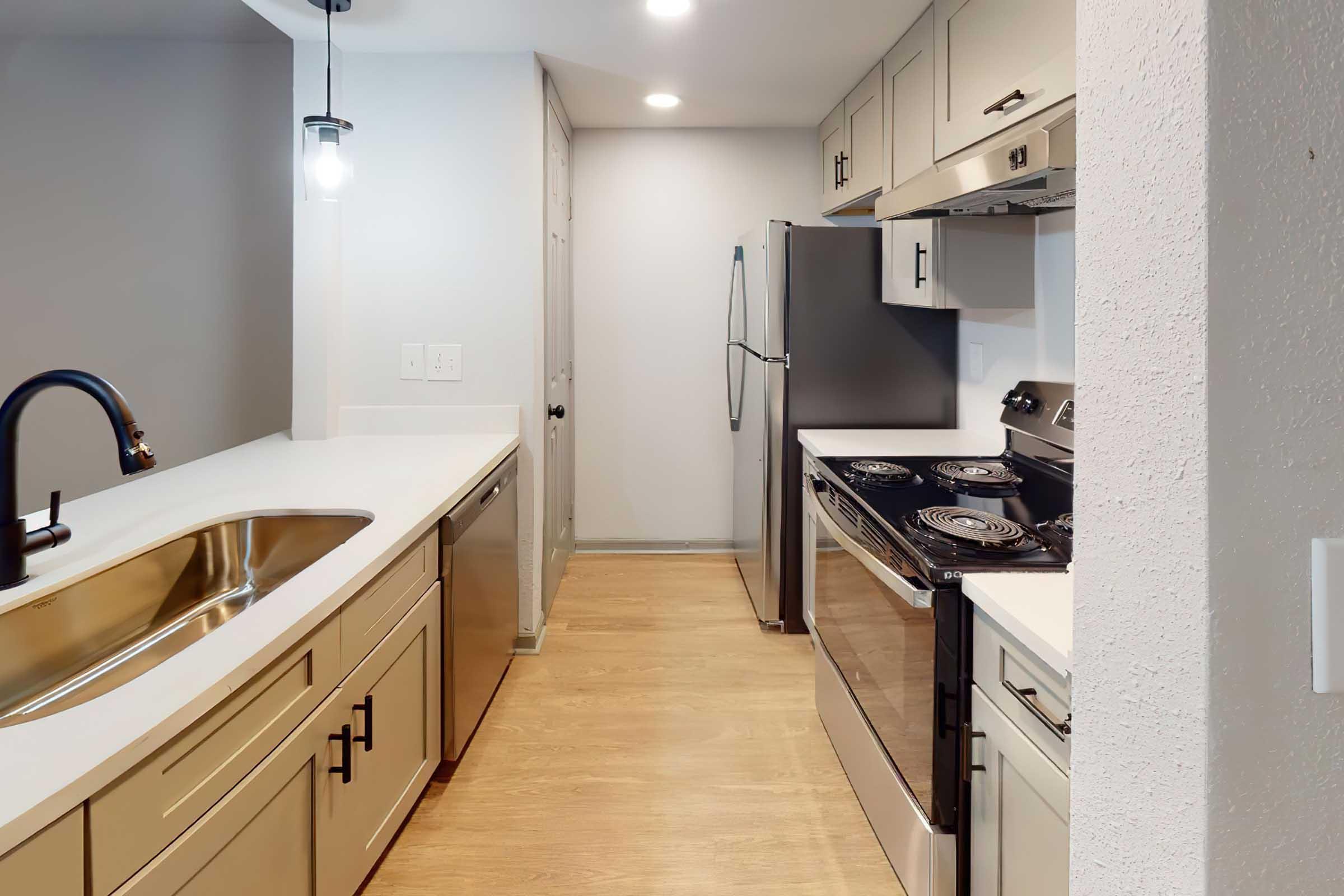 a kitchen with a stove sink and refrigerator