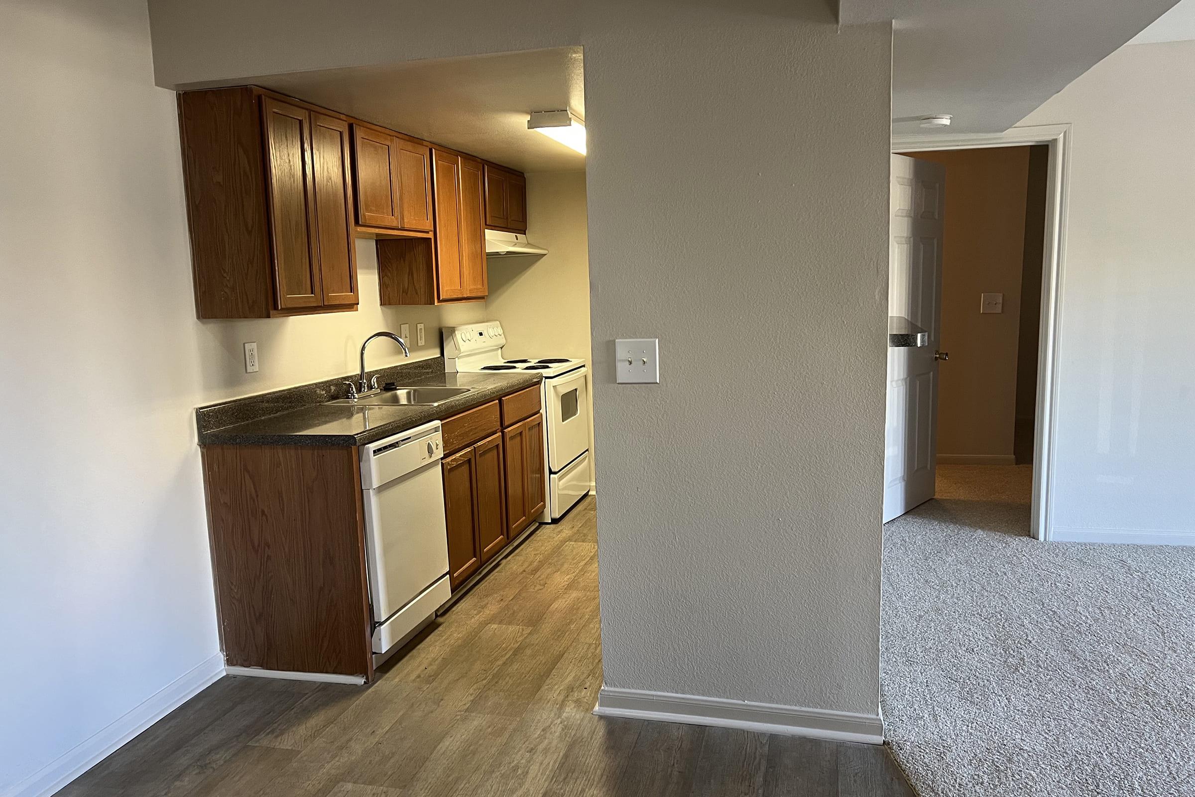 a kitchen with a sink and a mirror