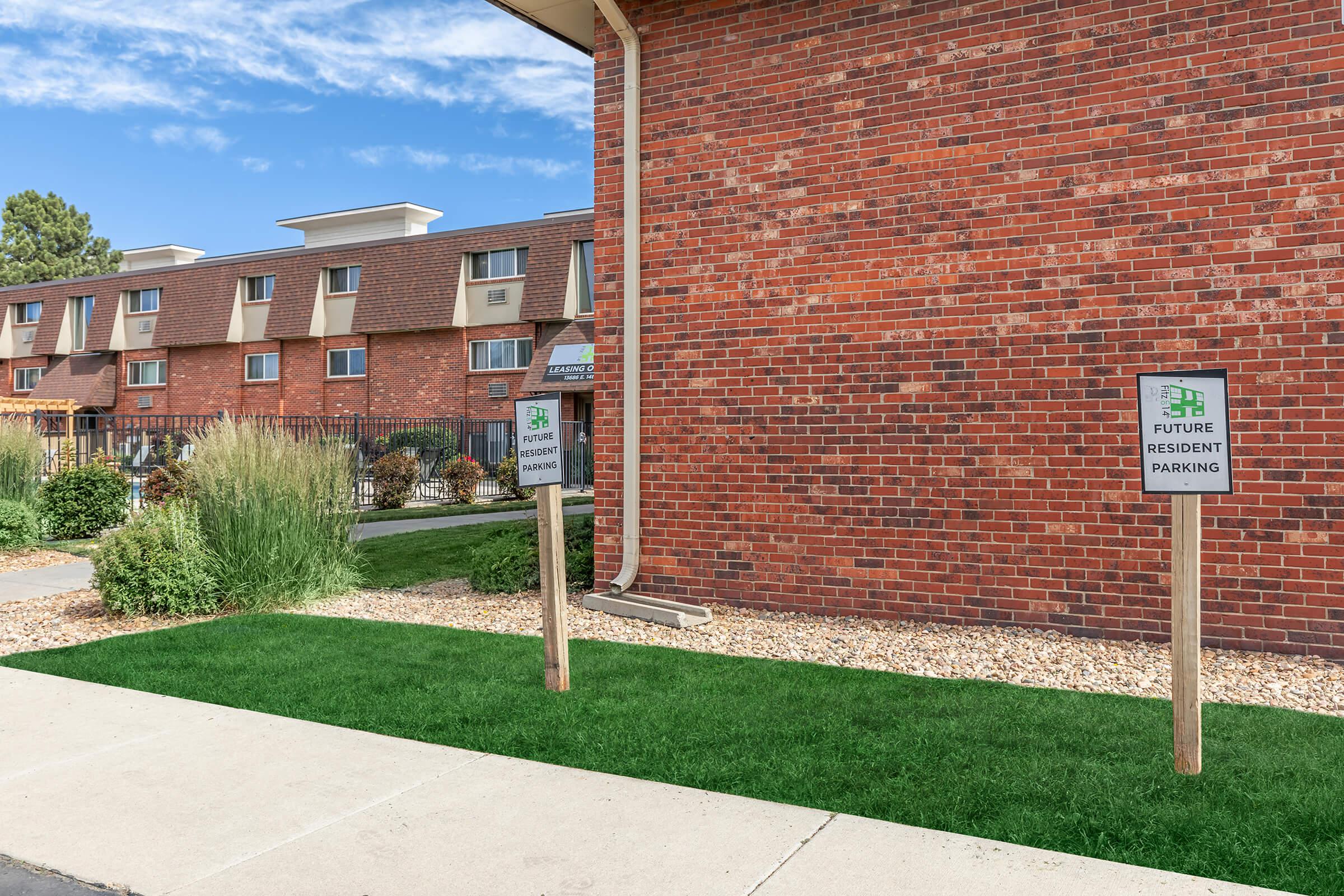 a sign in front of a brick building