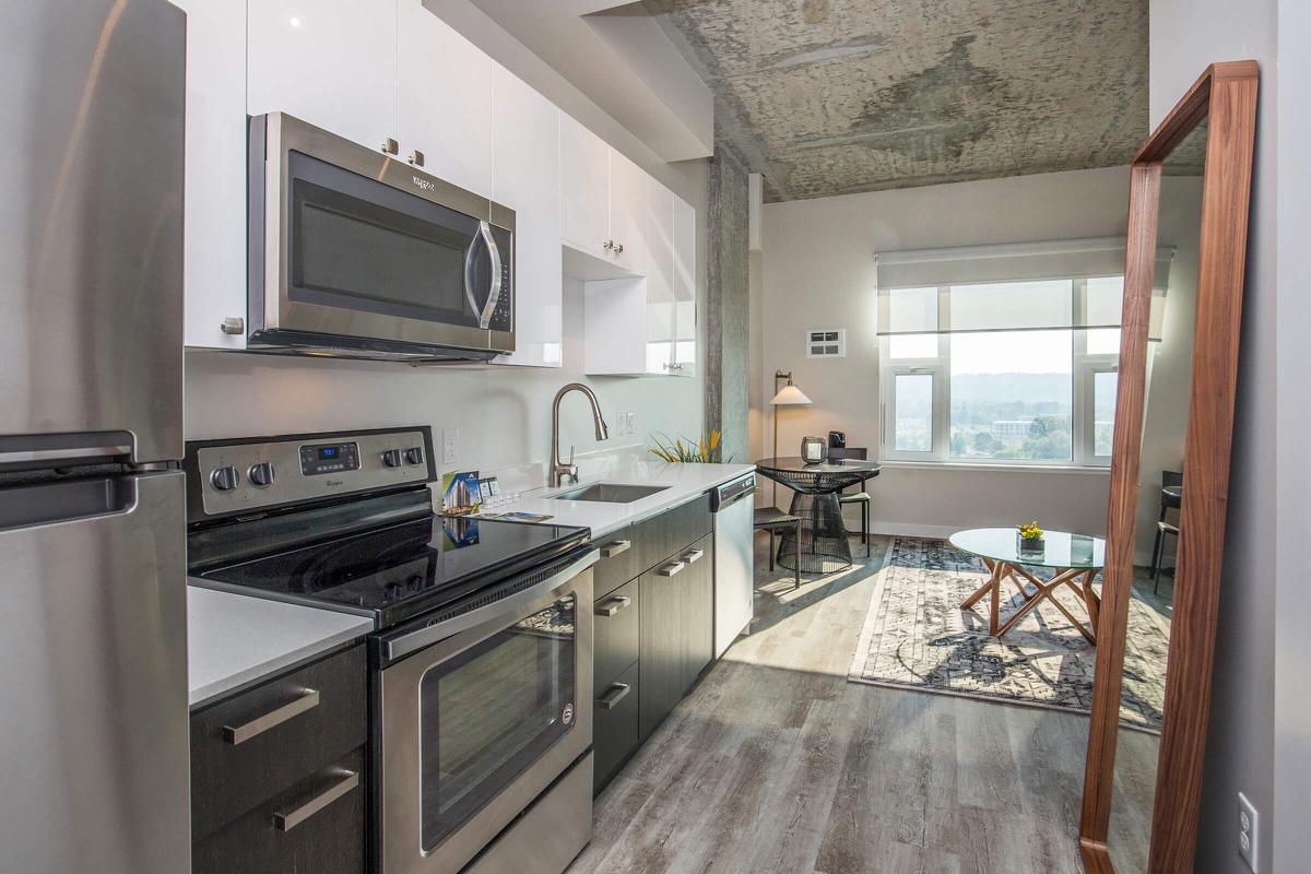 a kitchen with stainless steel appliances and wooden cabinets