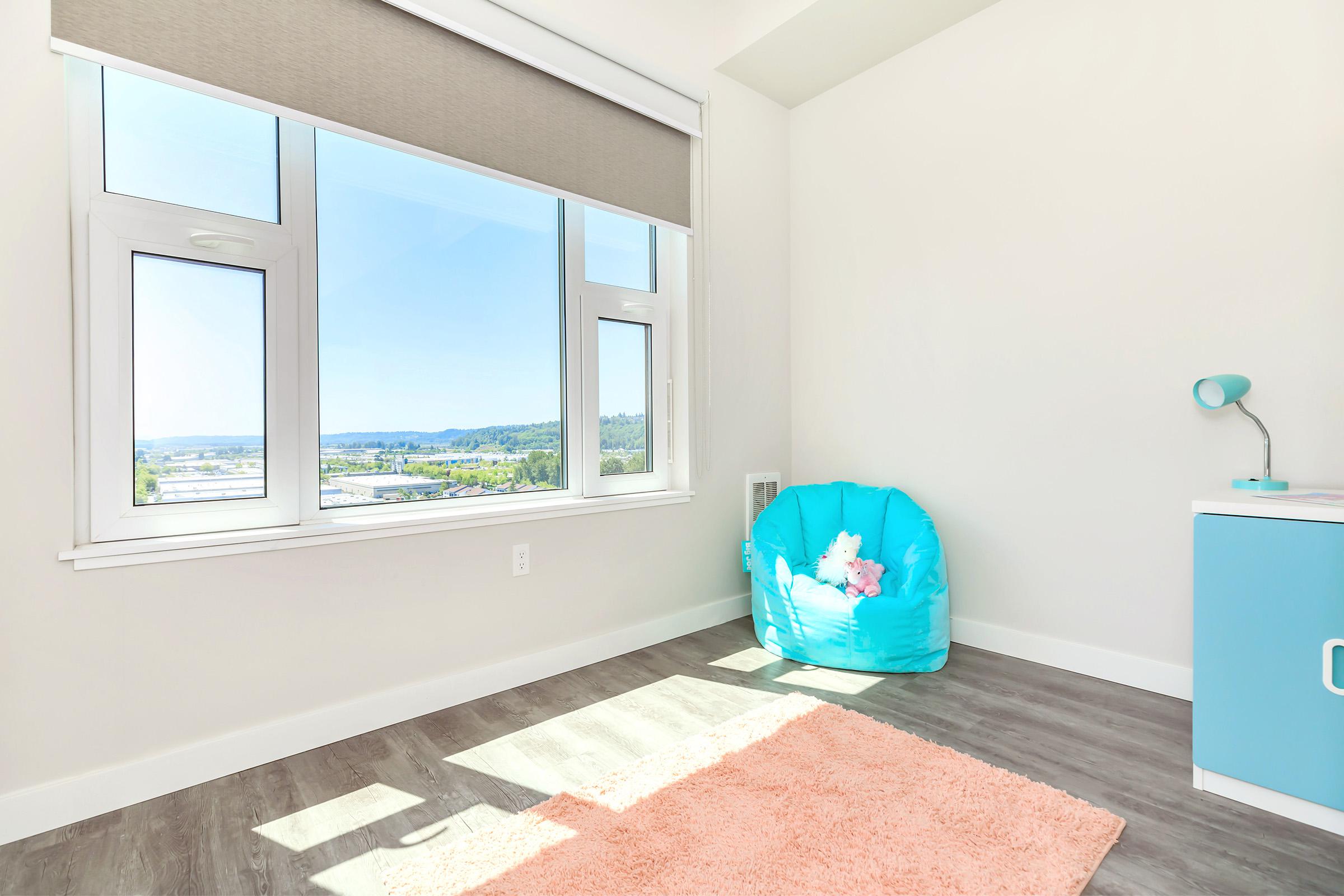 a room with blue walls and a large window