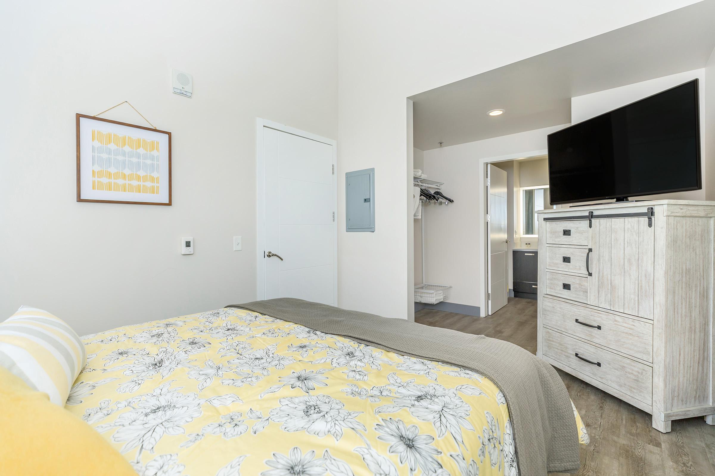 a bedroom with a bed in a room