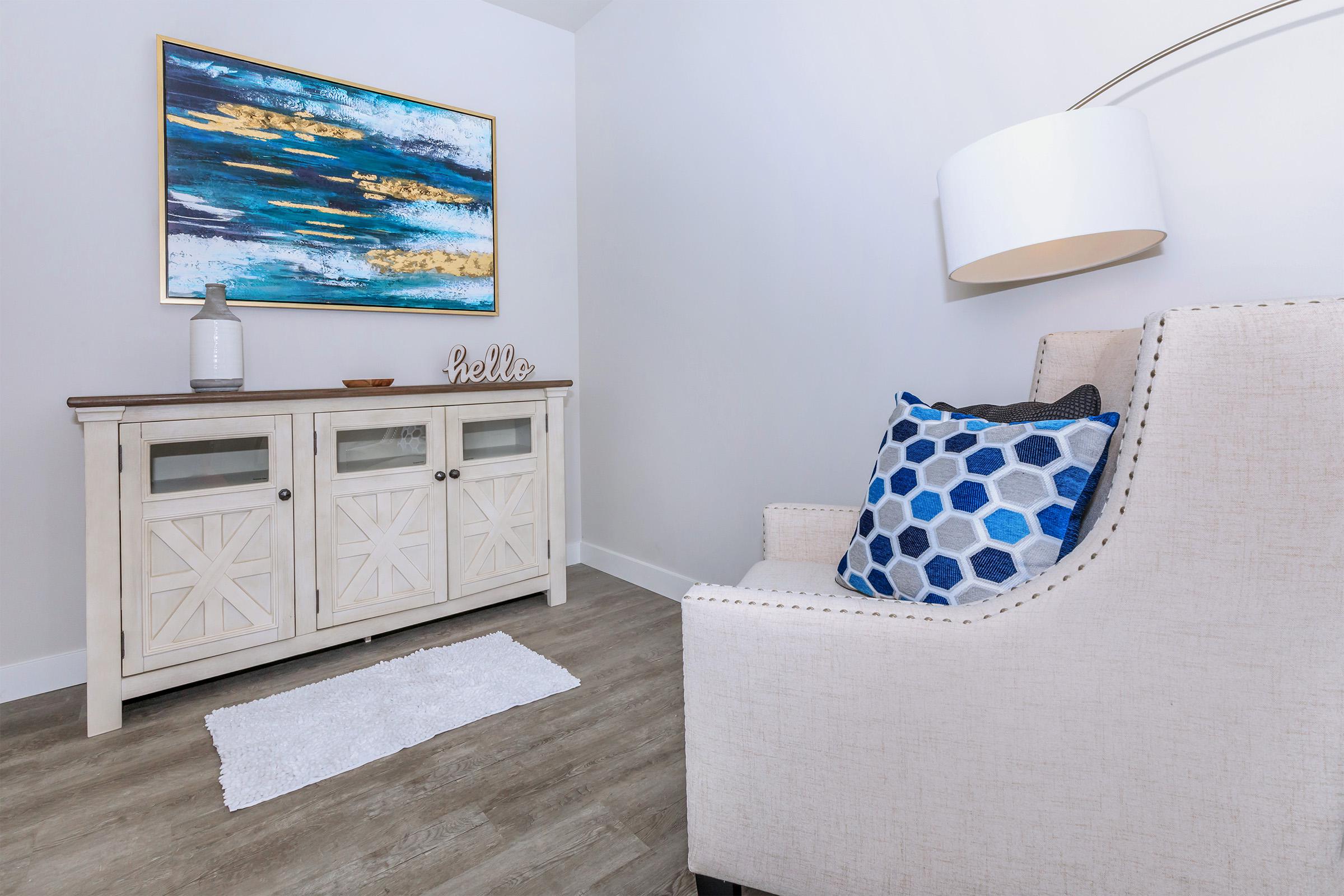 a bedroom with a bed and a mirror in a room