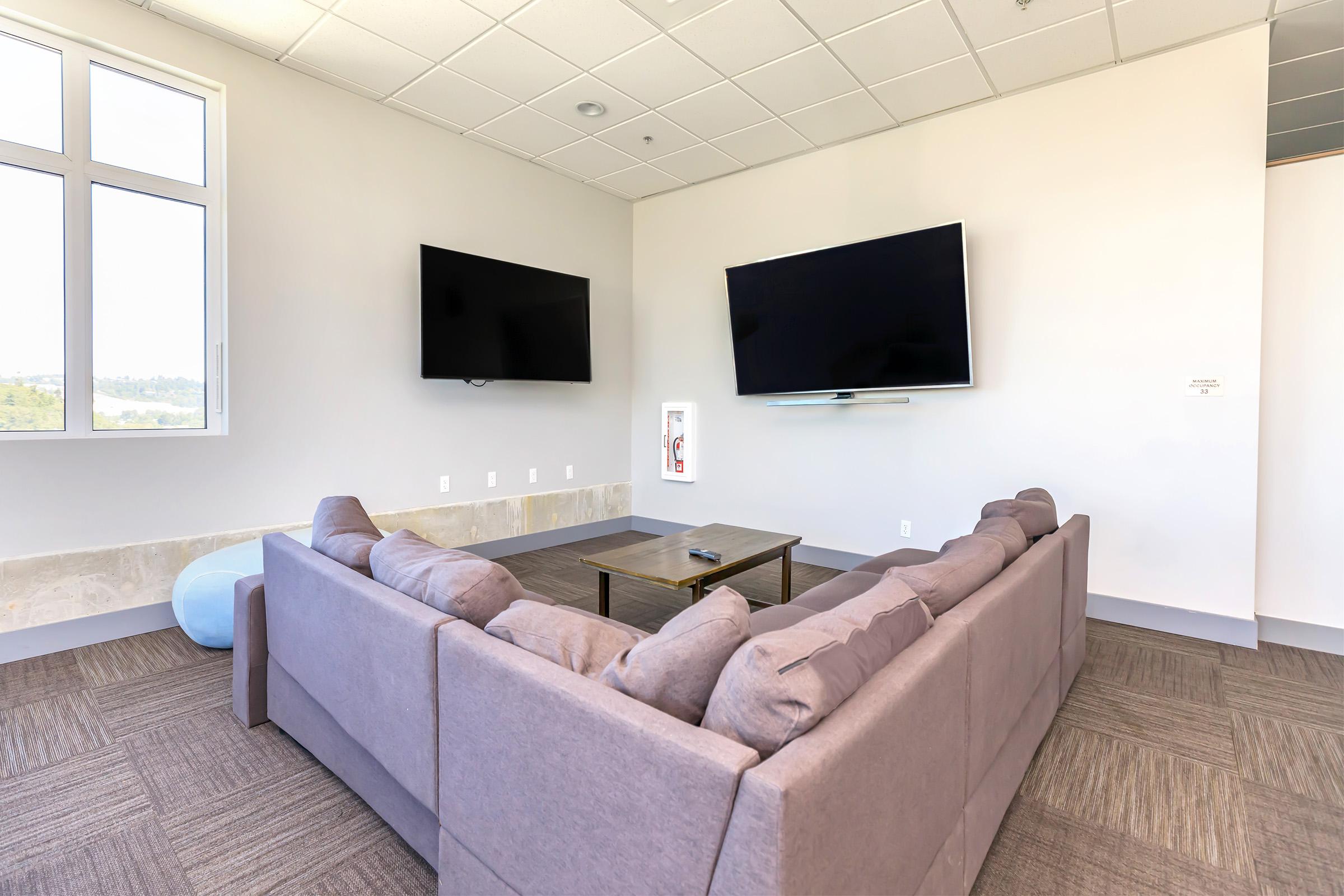 a living room filled with furniture and a large window