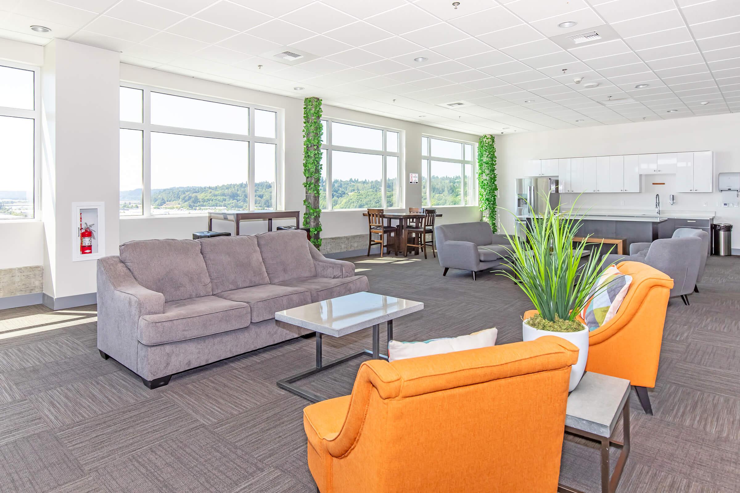 a living room filled with furniture and a large window