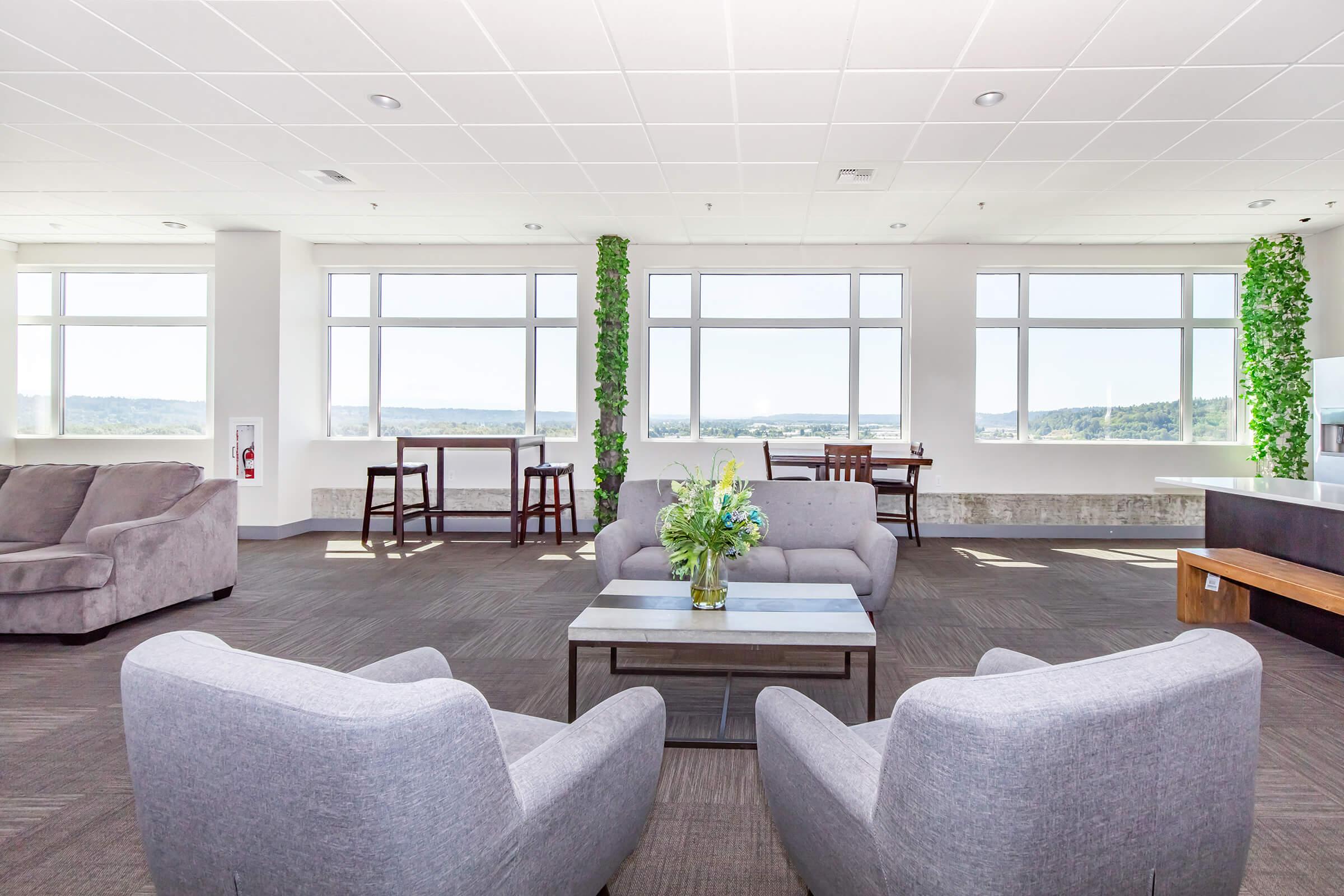 a living room filled with furniture and a large window