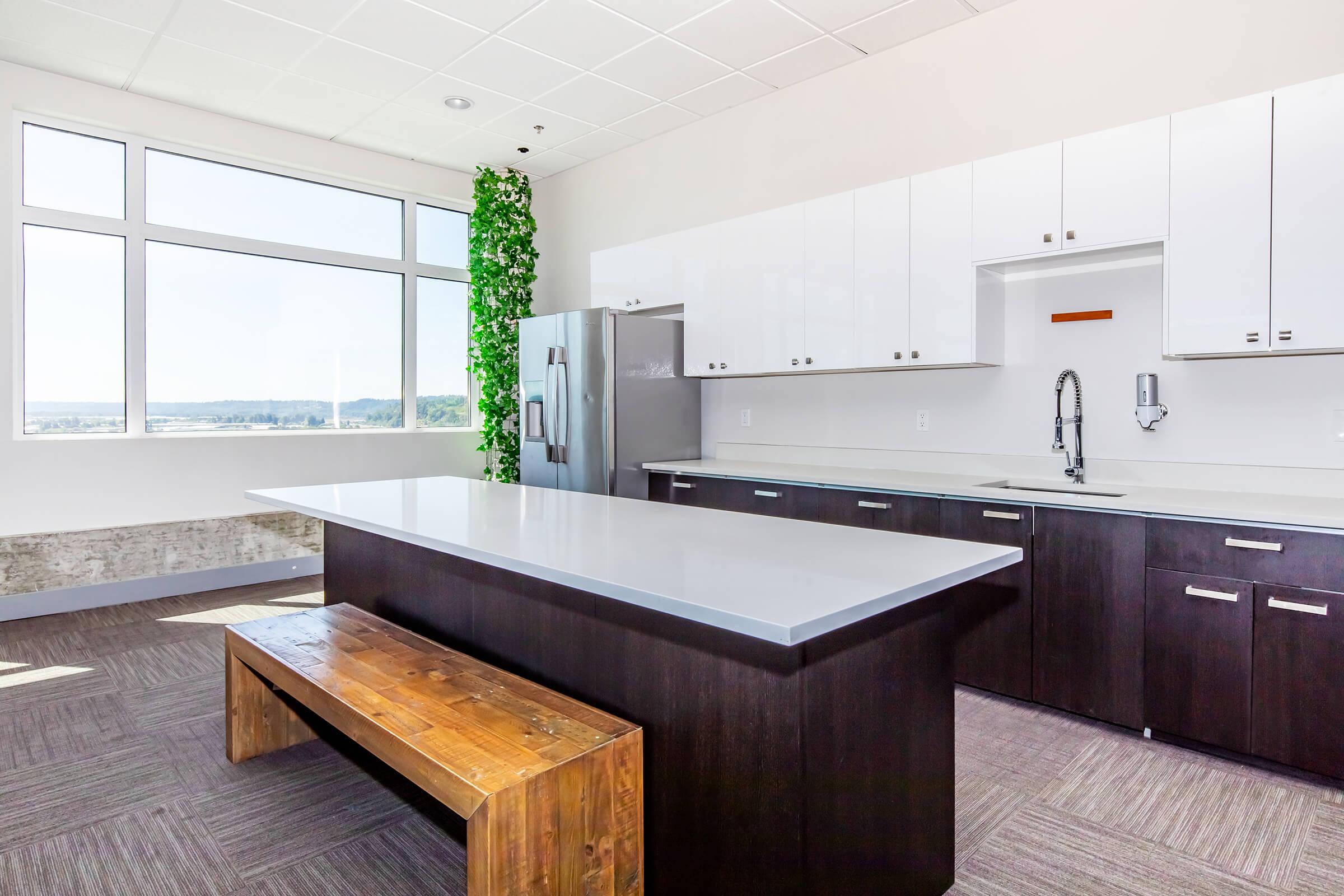 a modern kitchen with an island in the middle of a room