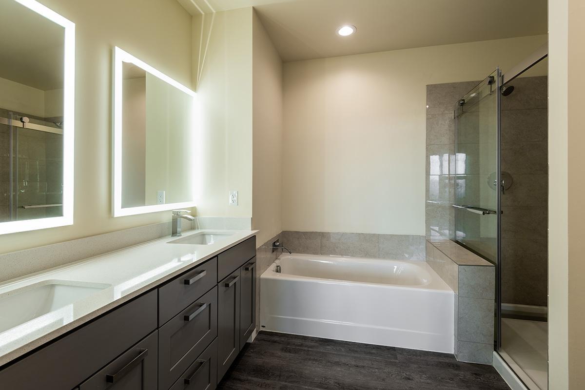 a large white tub sitting next to a window