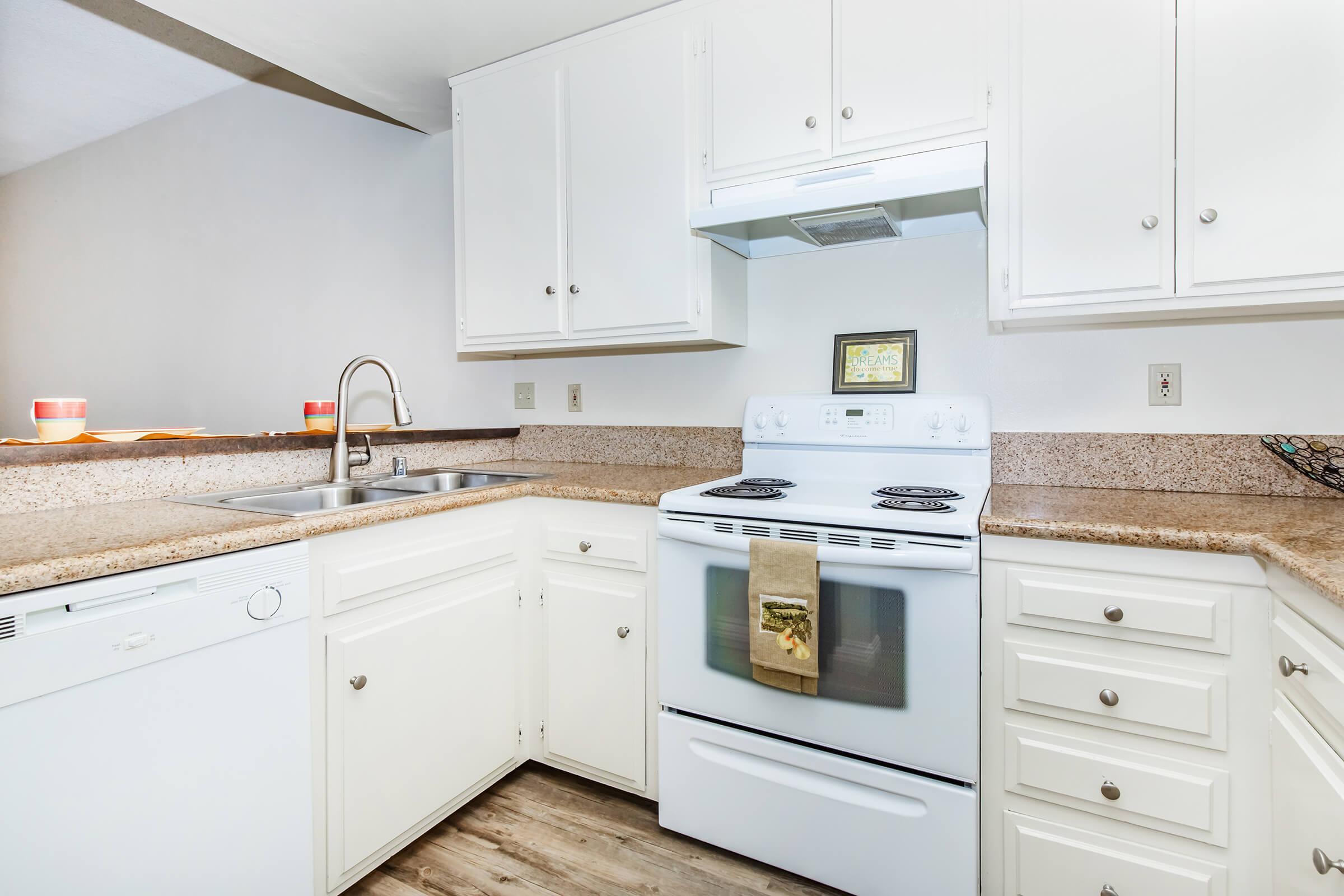 a stove top oven sitting inside of a kitchen