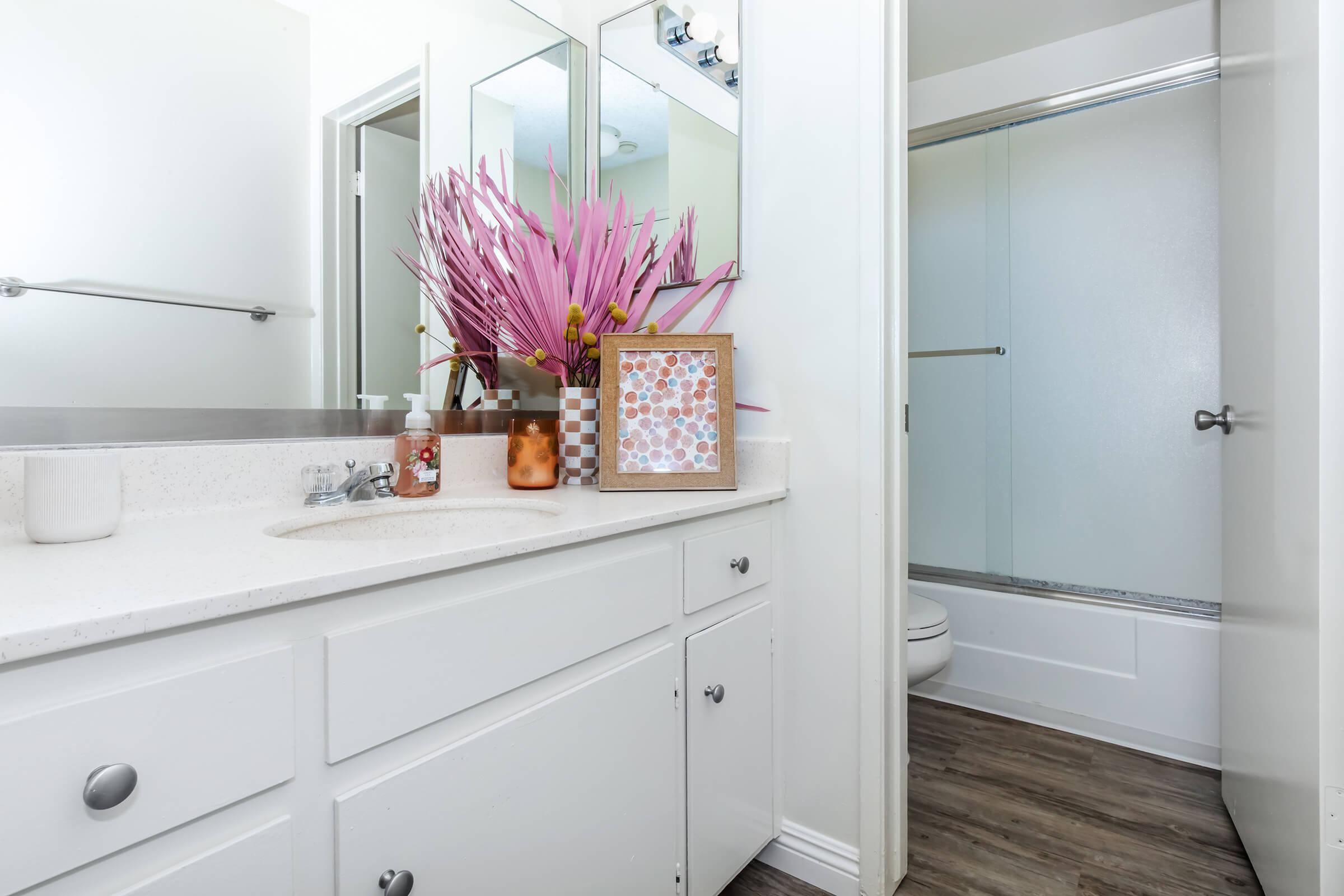 a kitchen with a sink and a mirror