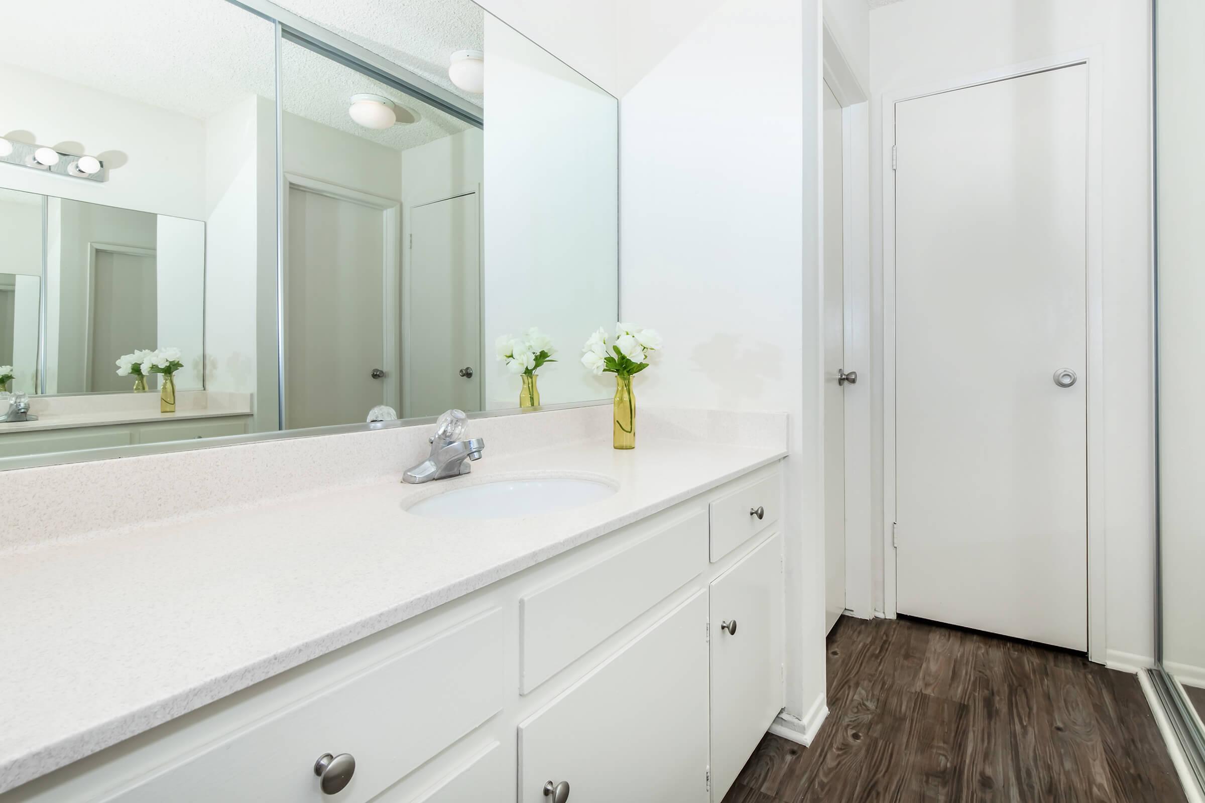 a kitchen with a sink and a mirror