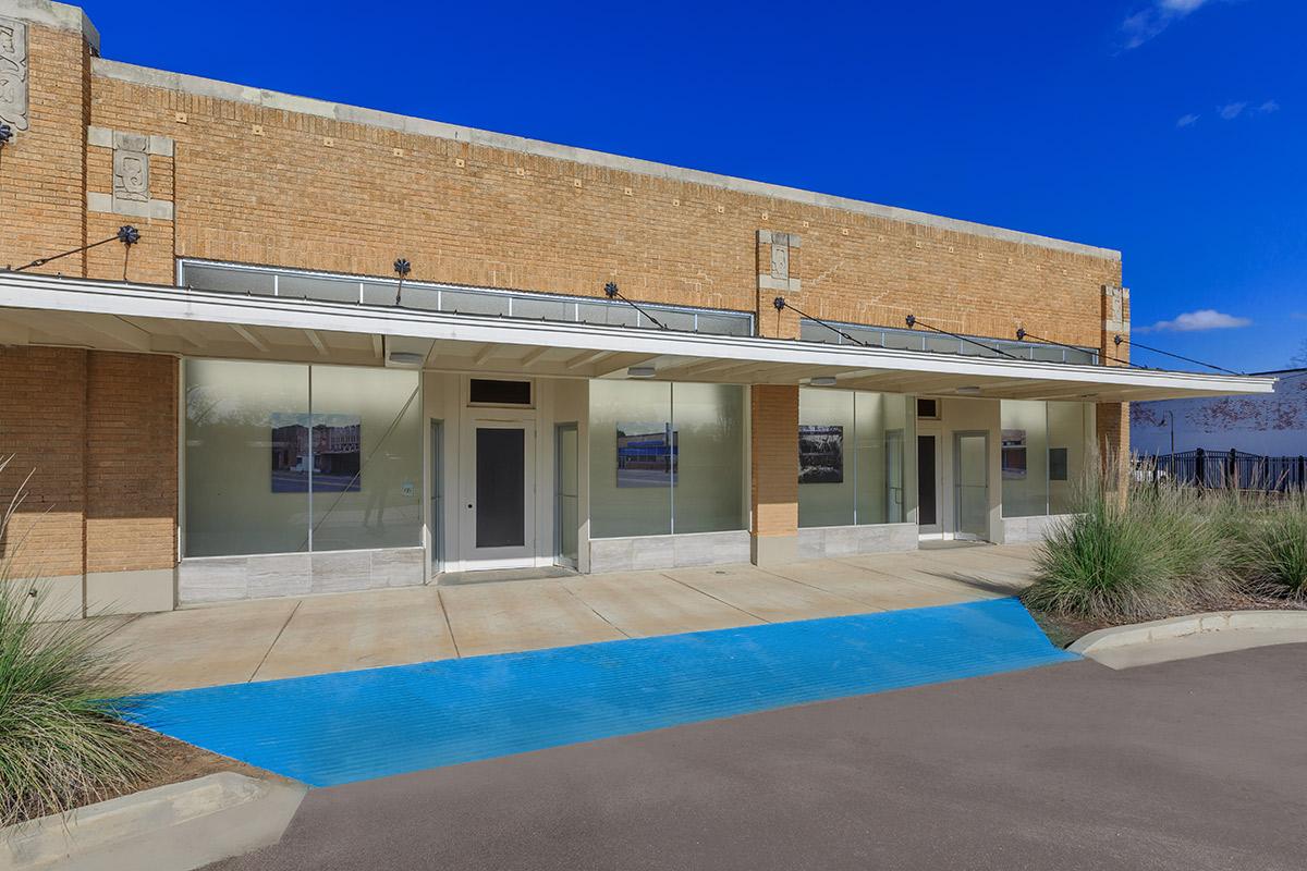 a large brick building with a pool in front of a house