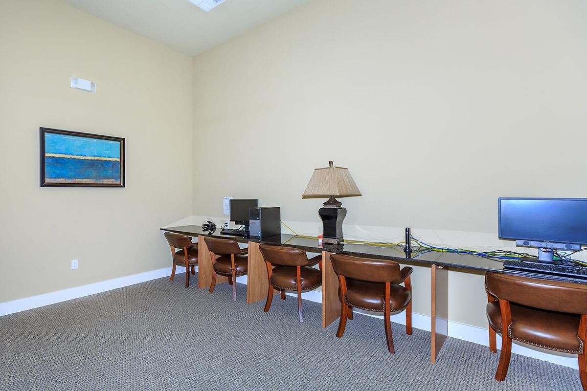 a bedroom with a desk and chair in a room