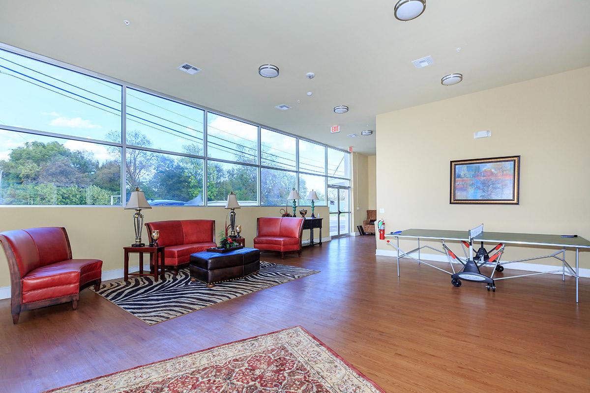 a living room filled with furniture and a flat screen tv