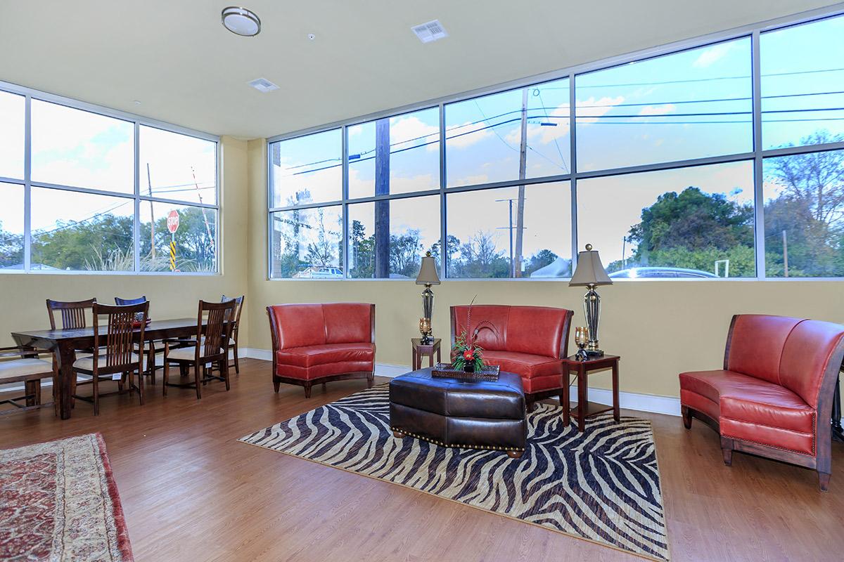 a living room filled with furniture and a large window