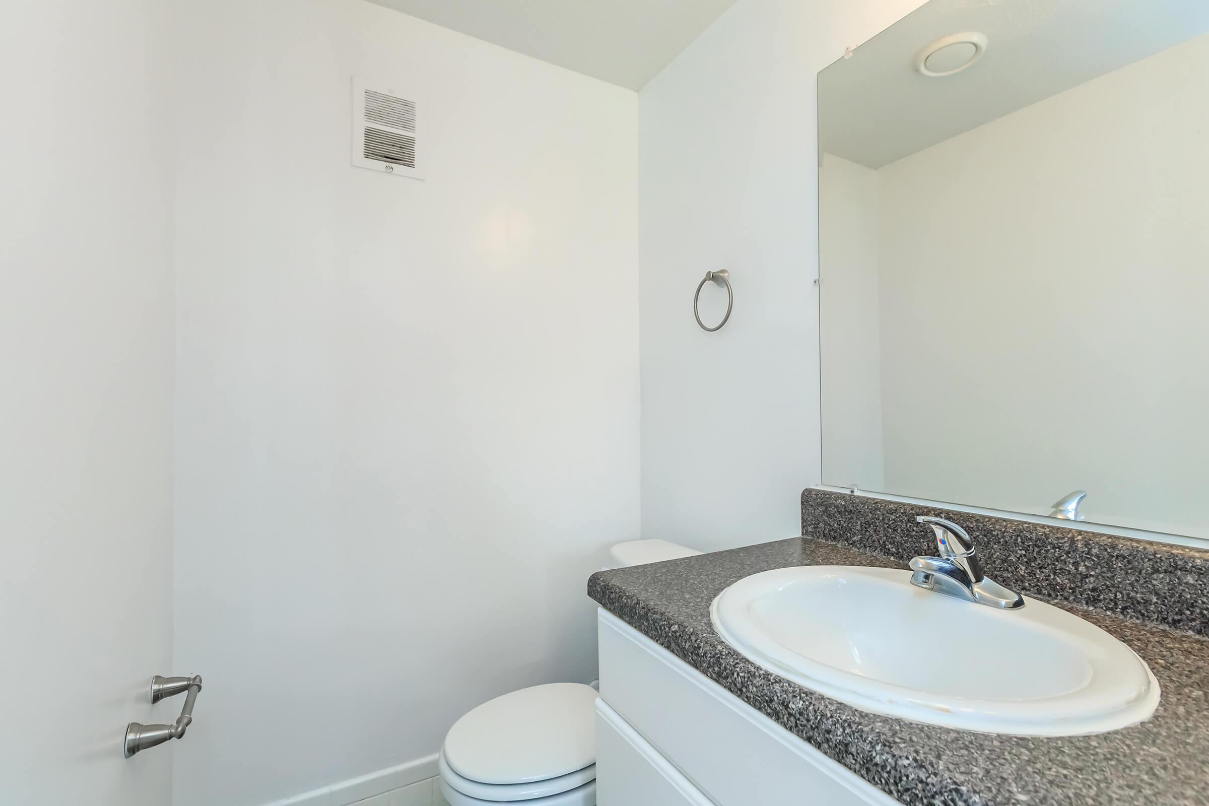 a white sink and a mirror