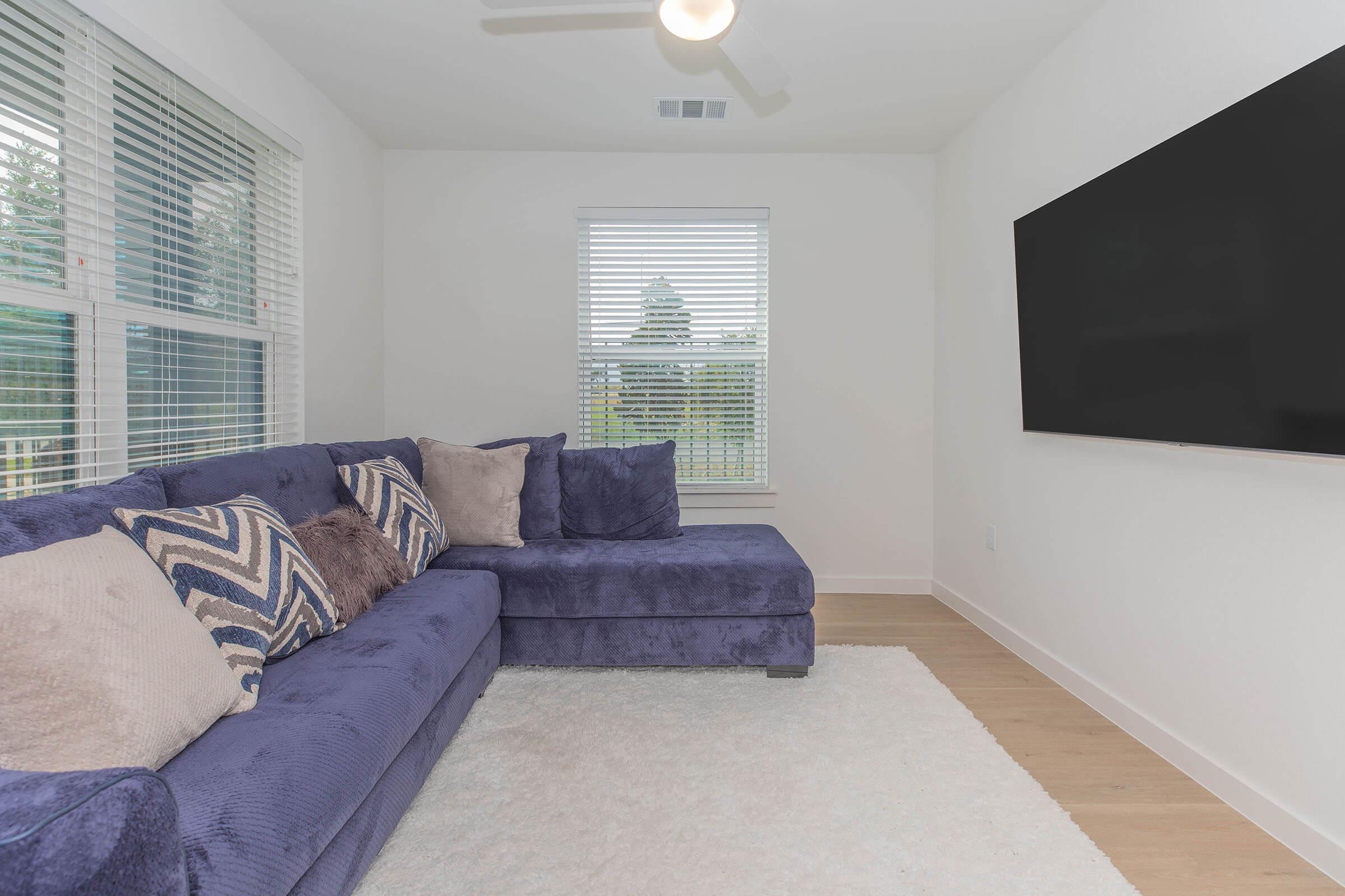 a living room filled with furniture and a large window