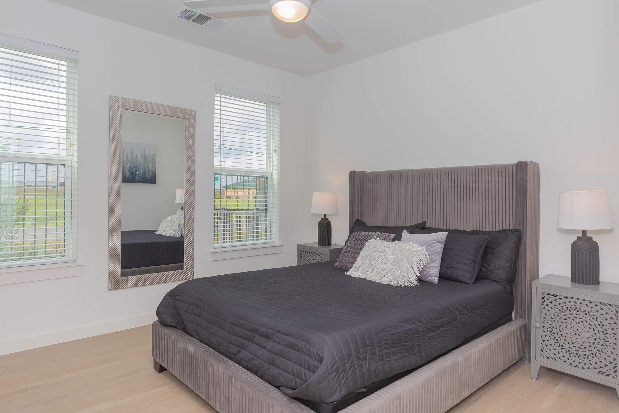 a living room with a bed and a window