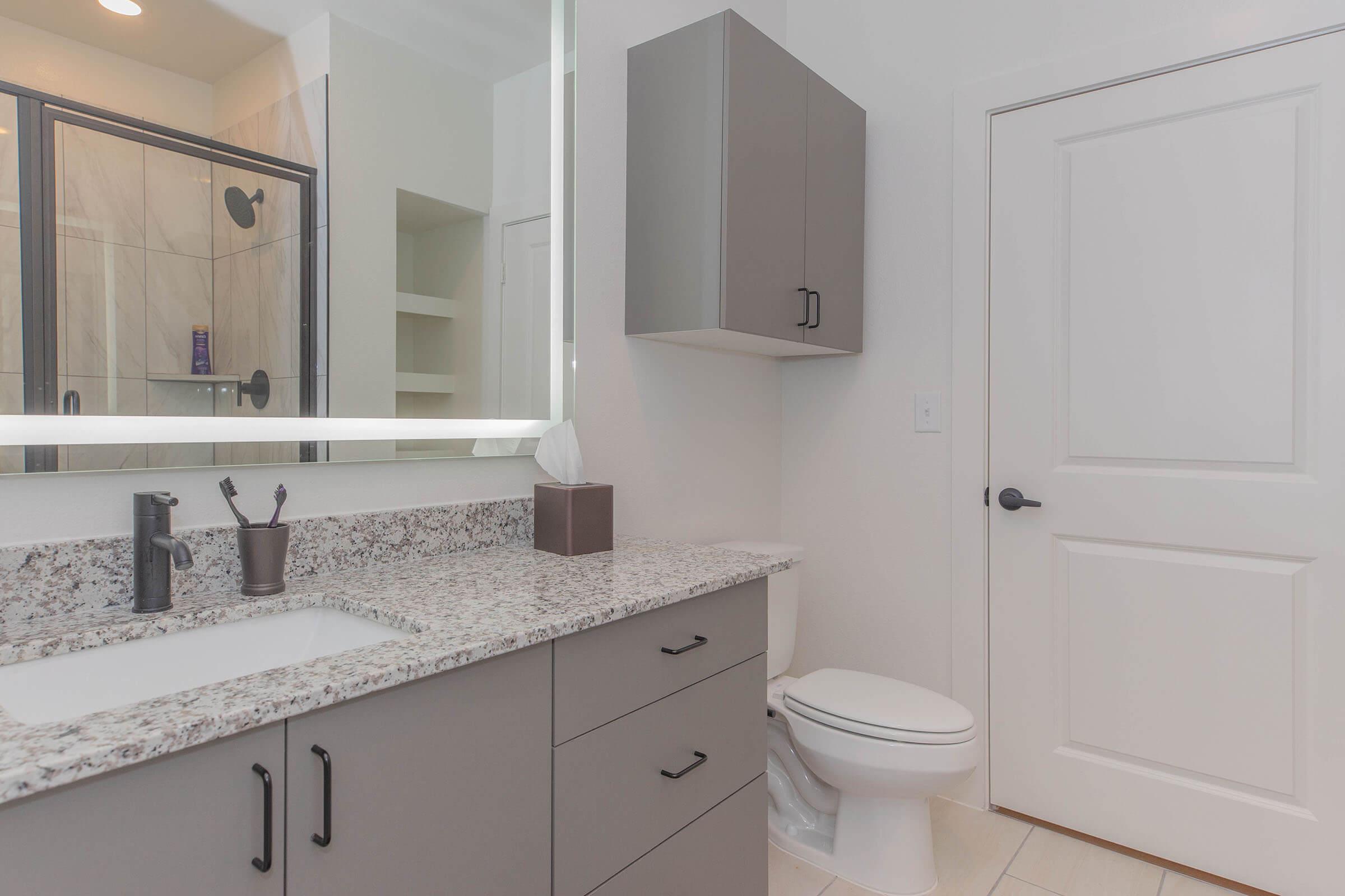 a kitchen with a sink and a mirror