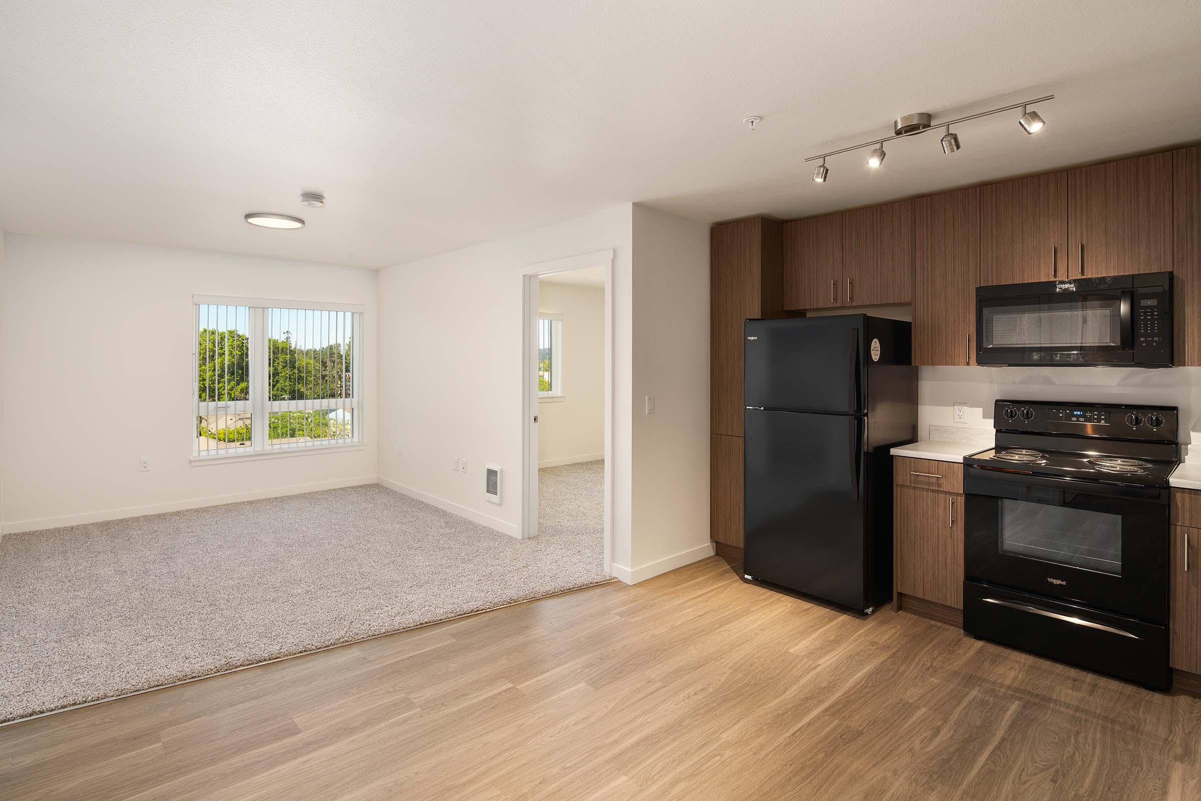 a large kitchen with stainless steel appliances and wooden cabinets