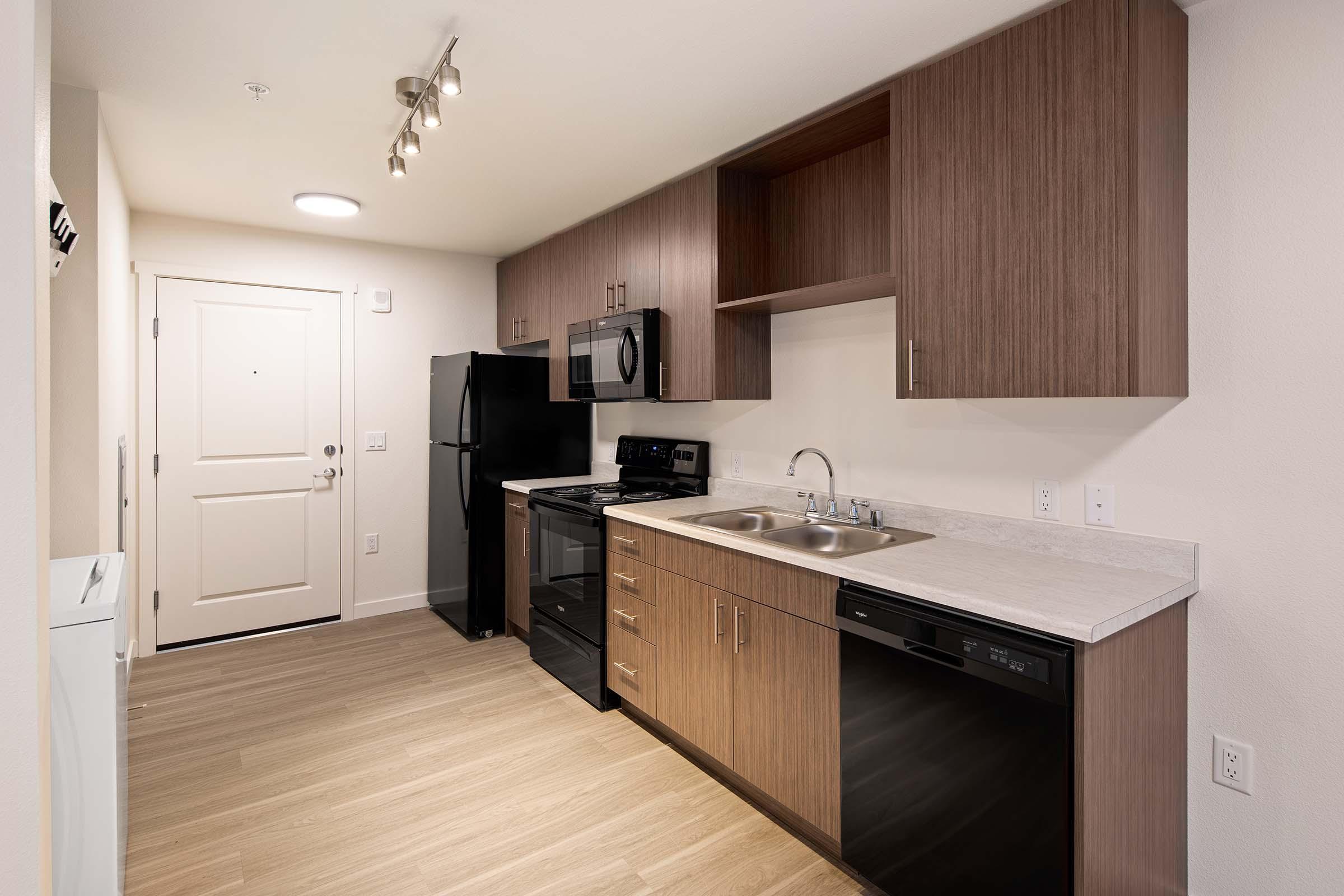 a kitchen with a sink and a refrigerator