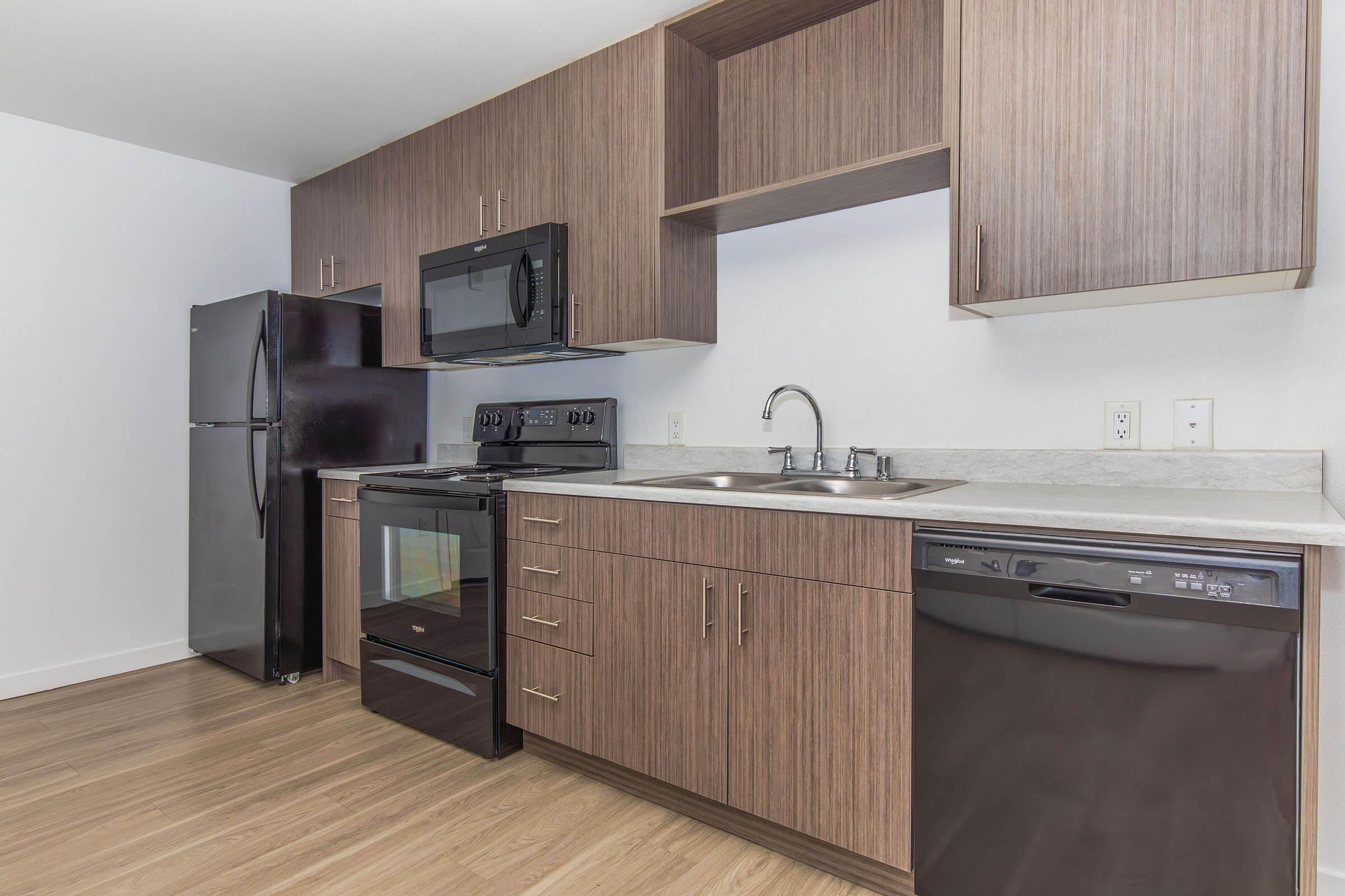 a kitchen with stainless steel appliances and wooden cabinets