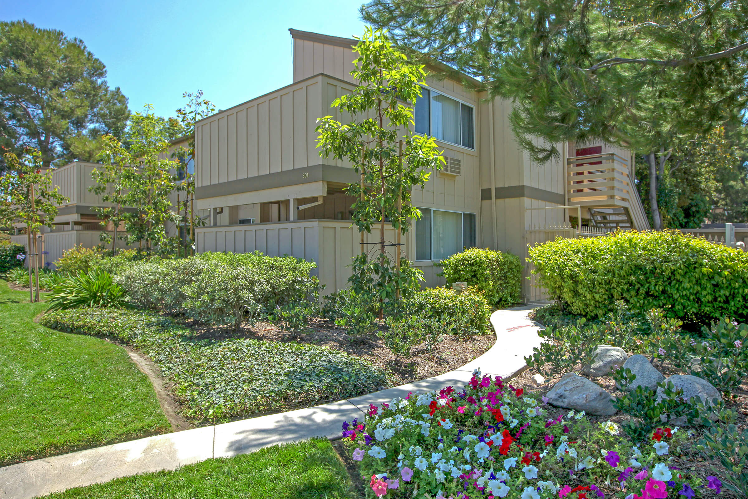 Highland Creek Apartment Homes community building with flowers