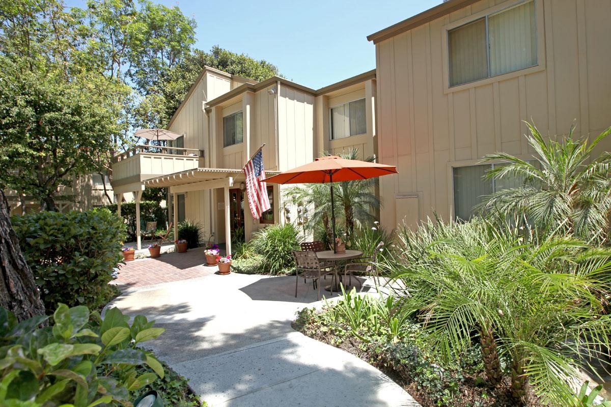 Highland Creek Apartment Homes community building with an american flag