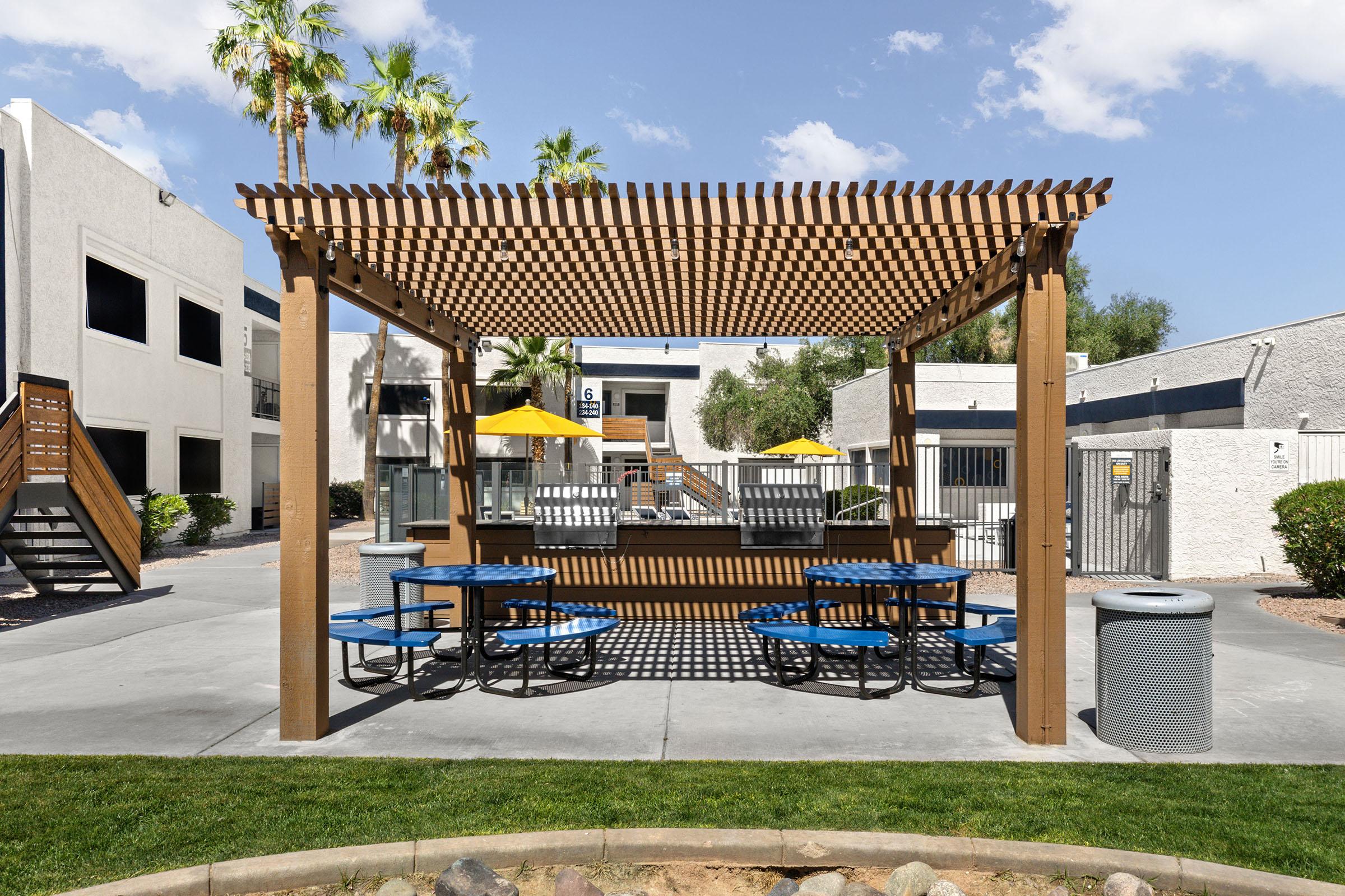 Outdoor picnic seating beside the apartment buildings.