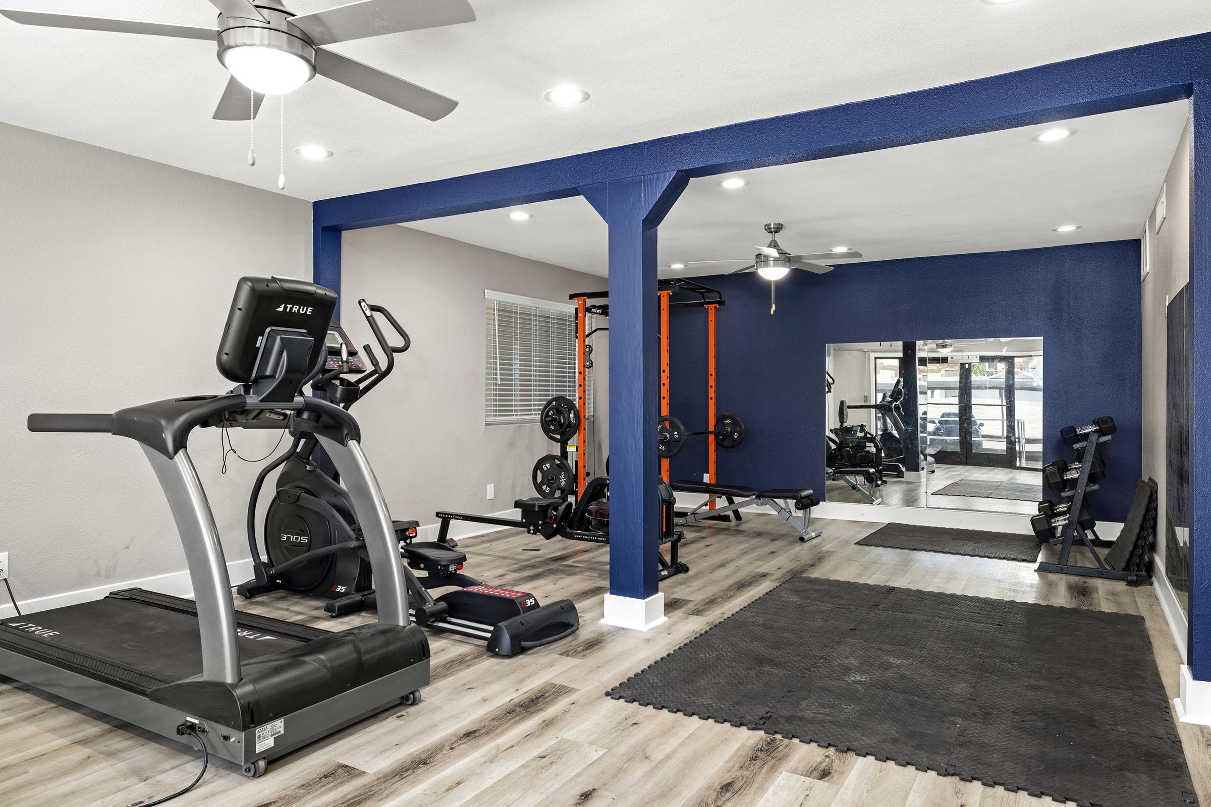 Fitness room with exercise equipment.