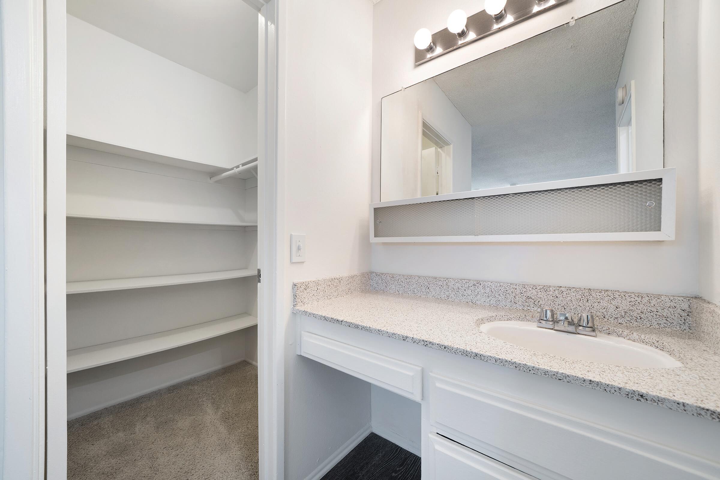 Unfurnished bathroom sink with open walk-in closet