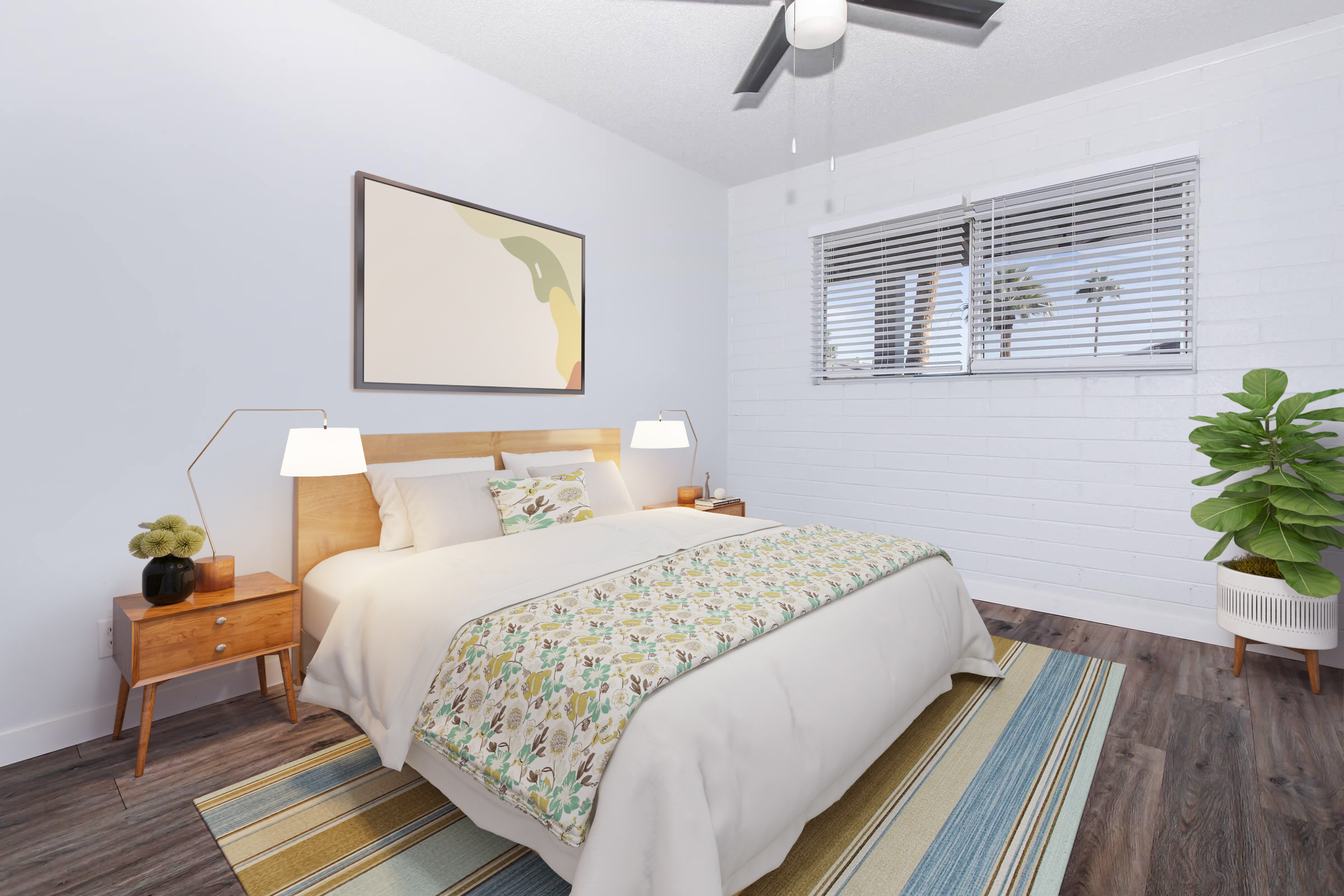 A cozy bedroom featuring a light-colored bed with a floral throw blanket, two bedside tables with lamps, and a potted plant. The walls are painted light blue, and there is a large abstract art piece above the bed. A window lets in natural light, illuminating the wooden flooring and striped rug.