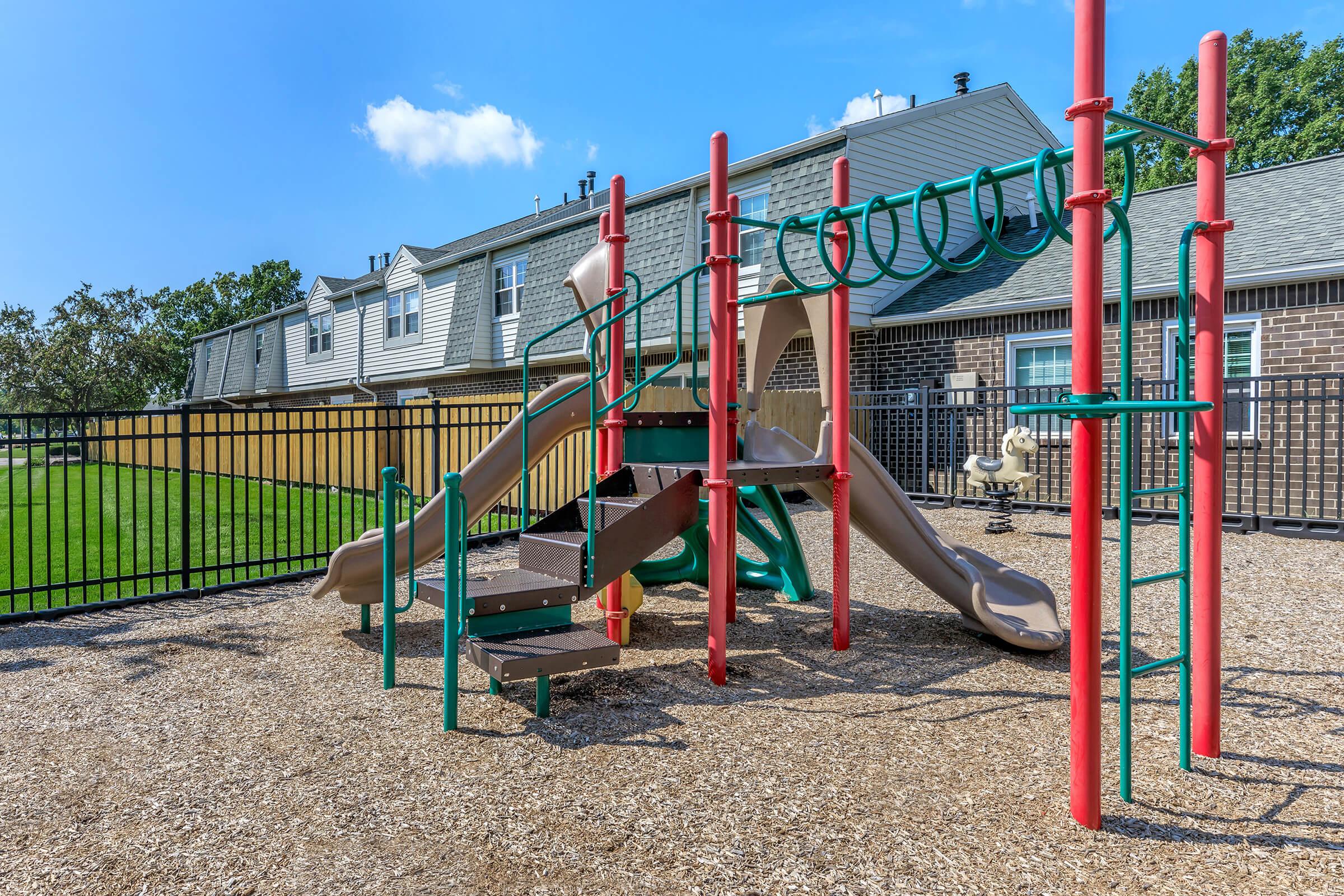 a playground in front of a fence