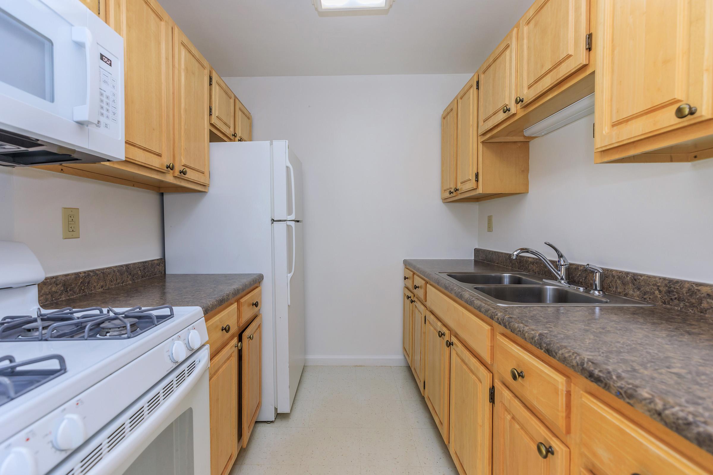 a stove top oven sitting inside of a kitchen