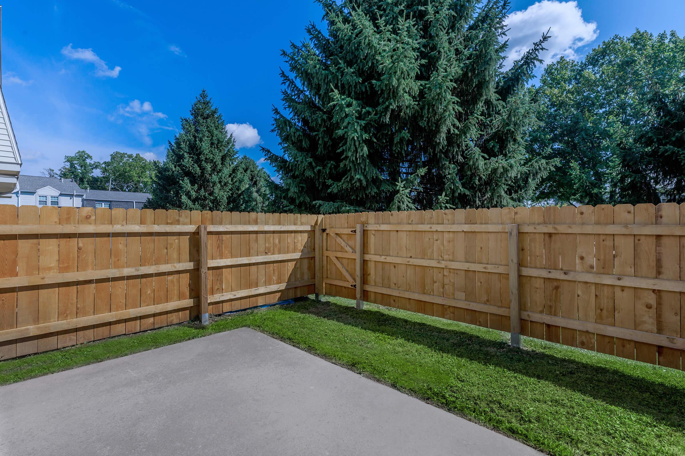 a path with trees on the side of a fence