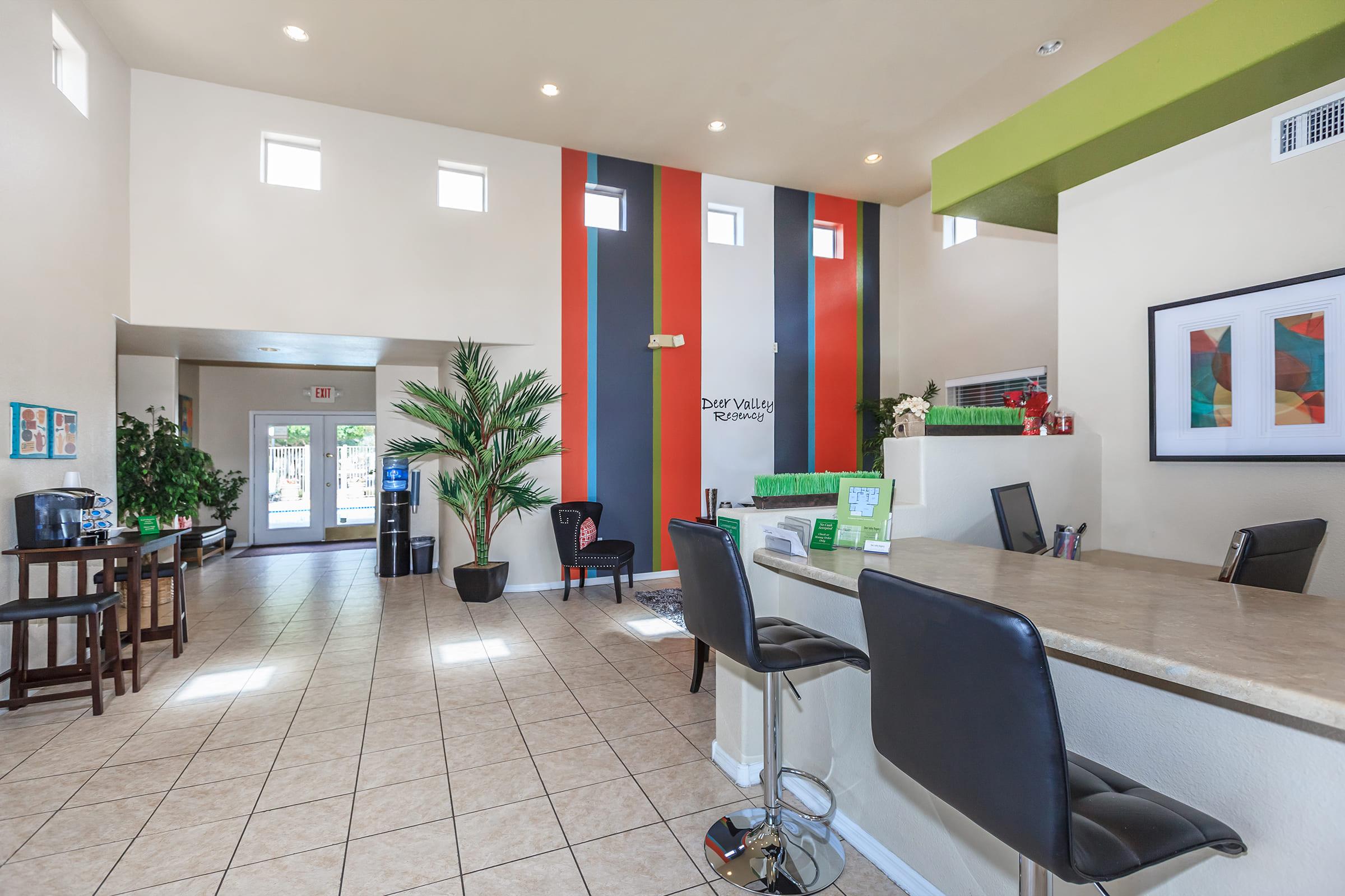 A modern reception area featuring a light color scheme with colorful accent walls.